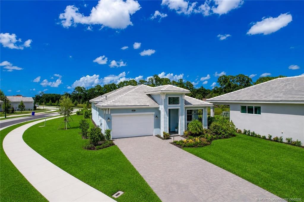 Refined Florida living awaits in impeccably built 2025 home on premium lot w/serene waterfront views in highly sought-after, SOLD-OUT comm. of Cove Royale in Stuart. Offering 3BR+Den/Flex Room, 3.5BA & epoxied 2CG w/ expansive paver driveway. Soaring ceilings, designer & recessed LED lighting,& no carpet throughout. The gourmet kitchen features stacked ceiling-height cabinetry, Cambria quartz countertops, handcrafted zellige tile backsplash, GE Profile SS natural gas appliances, oversized island, walk-in pantry & abundant storage. Great room showcases tiled electric fireplace & custom window treatments. Luxurious primary suite offers spa-inspired bath & custom closet systems. Upgraded baths, oversized laundry room w/cabinetry, quartz counters & utility sink. Enjoy covered front & rear outdoor living, screened lanai, cabana bath, fenced yard & peaceful water views. Add'l features incl. impact windows & doors, cement tile roof, natural gas & walking access to resort-style community pool.