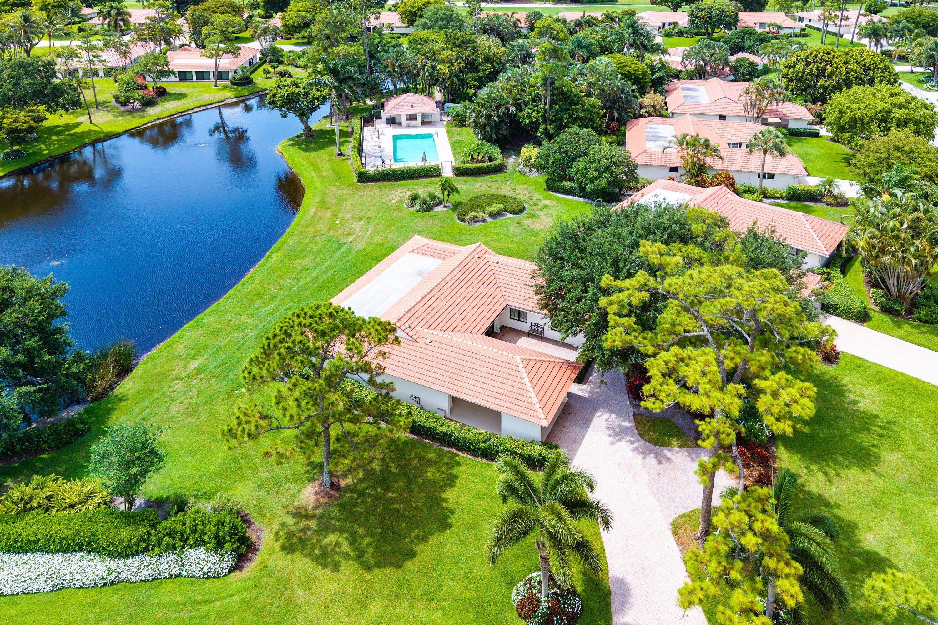 Welcome to this beautifully appointed villa in the Shelldrake area of Quail Ridge, offering a private corner location, tranquil lake views and effortless indoor-outdoor living. This 3 bedroom/2.5 bath home features a spacious open floor plan. The chef's kitchen boasts a large center island, abundant cabinetry, and seamless flow into the living and dining areas. Impact glass windows flood the home with natural light while showcasing serene water views throughout. Ideally located with no neighbors on one side and very close to all club amenities. Mandatory membership includes two championship golf courses, racquet sports, spa, fitness center, and fine dining — all within a 24-hour guard-gated, Audubon-certified community.