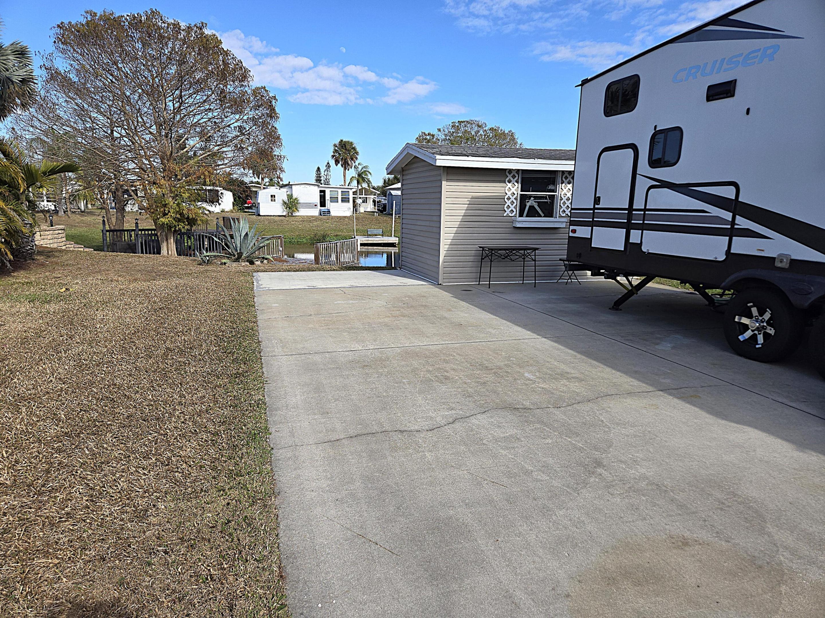 BLUE CYPRESS GOLF & RV RESORT - Lot 63 - Beautifully appointed improved, waterfront lot is ready for your seasonal or permanent new home or RV.  This active 55+ community offers it all:  9-hole golf course, clubhouse, pool, various activities, fishing and boat ramp; which allows for Lake Okeechobee access.

Lot 62 is also available for purchase and could be sold as a package deal.