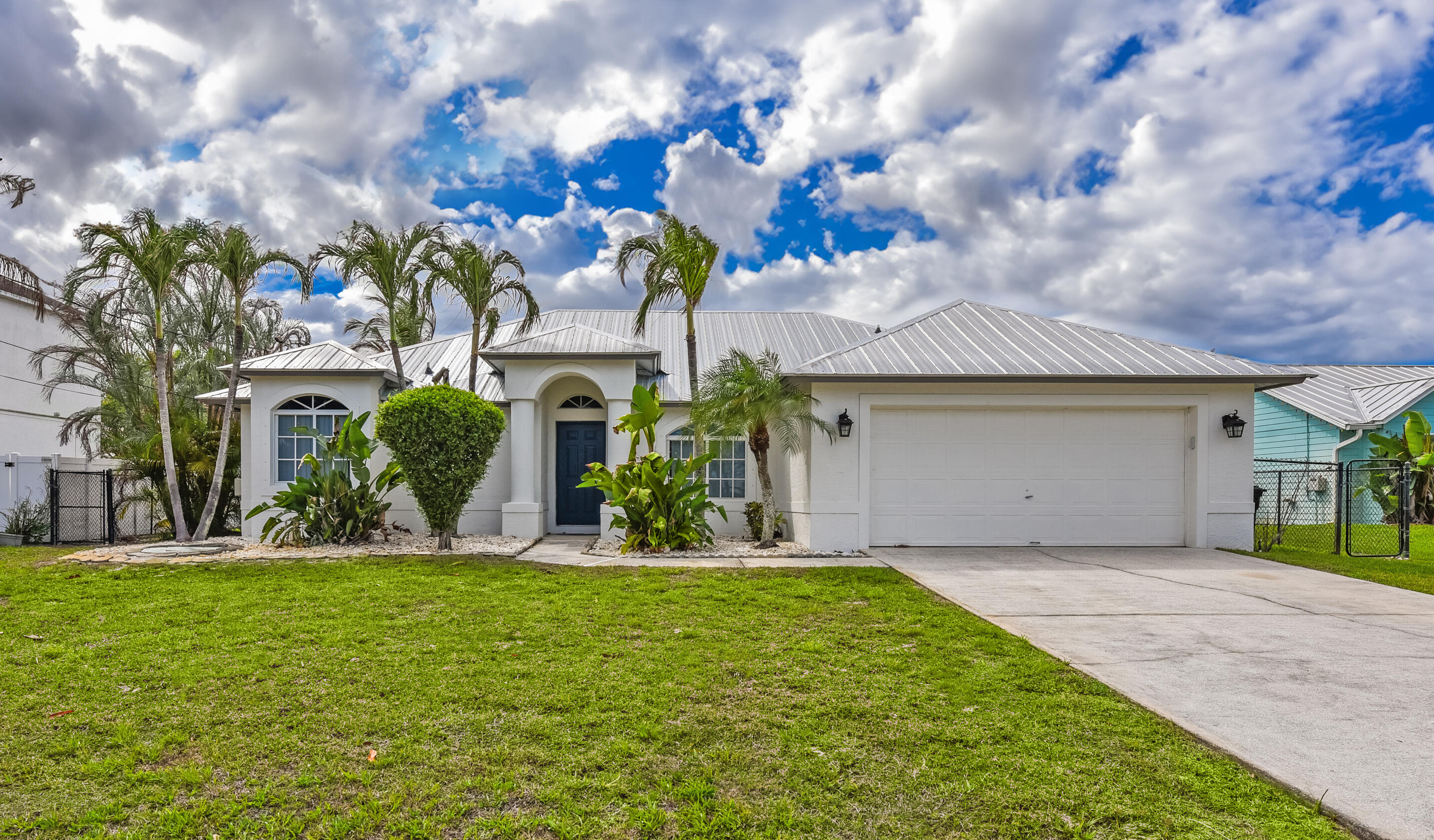 This 2006 concrete block home has a newer metal roof. There are split bedrooms, a two-car garage and many upgrades. The layout is designed with a contemporary feel and includes a formal living room, dining room, a family room and a breakfast nook area. The primary bedroom features a walk-in closet, an updated bathroom with dual sinks, a Roman tub, and a separate shower. The kitchen has been updated as well with granite countertops. There is tile flooring throughout, no carpet. There is an underroof screened covered porch and a large, fenced yard as well as a sprinkler system. This home is ready to move in!