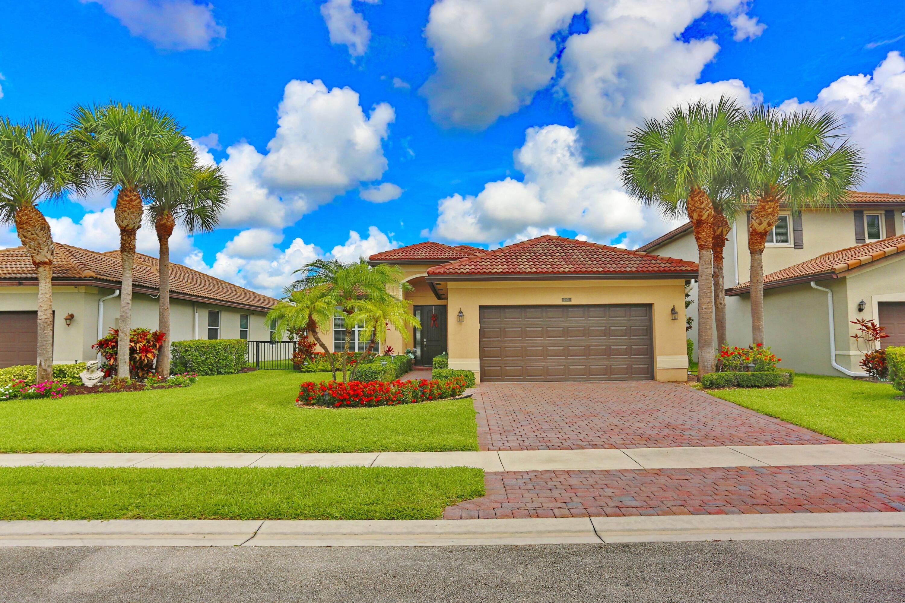 WELCOME HOME! This beautifully maintained 3-bedroom, 2-bath waterfront home is located in the quaint community of Vista Lago. Built in 2015 and zoned for highly rated schools, this move-in-ready home is conveniently located near shopping, dining, and approximately 4 miles from I-95. Features include impact windows and doors, hurricane panels for the glass block, no carpet throughout, a 2-car garage, and a paver driveway. Relax and unwind on the gorgeous covered and screened patio, complete with extended pavers and beautiful views of the lake, fountains, and breathtaking sunsets. Lovingly cared for by an impeccable "original" owner, this home truly shows pride of ownership! Refrigerator in garage conveys. 75% of furniture is negotiable.