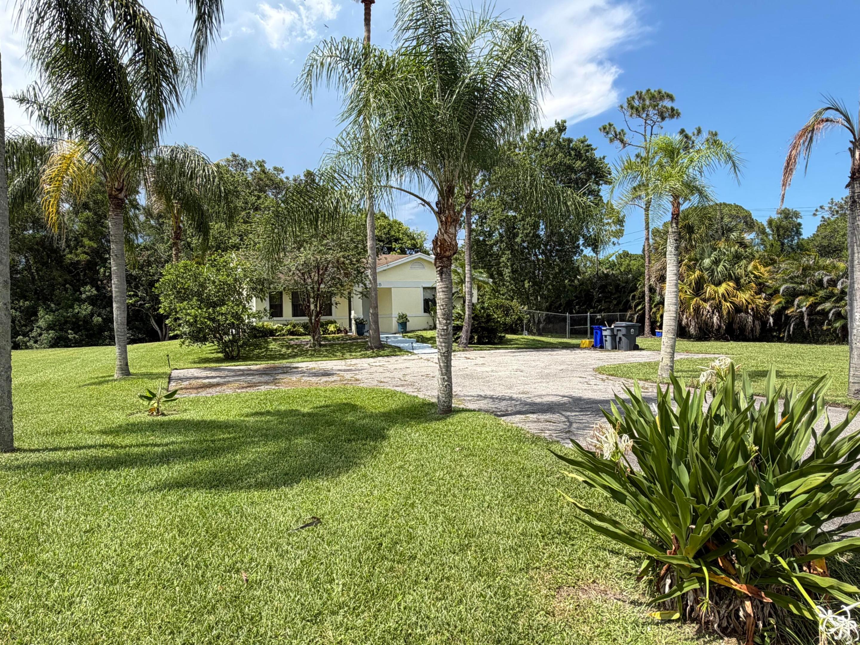 Experience the freedom of country living without sacrificing convenience in this charming 3-bedroom, 2-bathroom home situated on a private 1.15-acre lot in the desirable Loxahatchee/Acreage area. With no HOA restrictions, you'll have plenty of room for your boats, RVs, toys, pets, or future additions. Surrounded by open space and natural beauty, this property offers the privacy and tranquility you've been searching for while remaining just minutes from top-rated schools, shopping, restaurants, and everyday conveniences. The spacious lot provides endless possibilities for outdoor enjoyment, featuring a large open patio perfect for entertaining, family events, weekend barbecues, or simply relaxing and taking in the peaceful surroundings.  Whether you're looking for room to grow or a place to enjoy the Florida lifestyle at your own pace, this property offers a rare opportunity to own acreage in a highly sought-after location.
