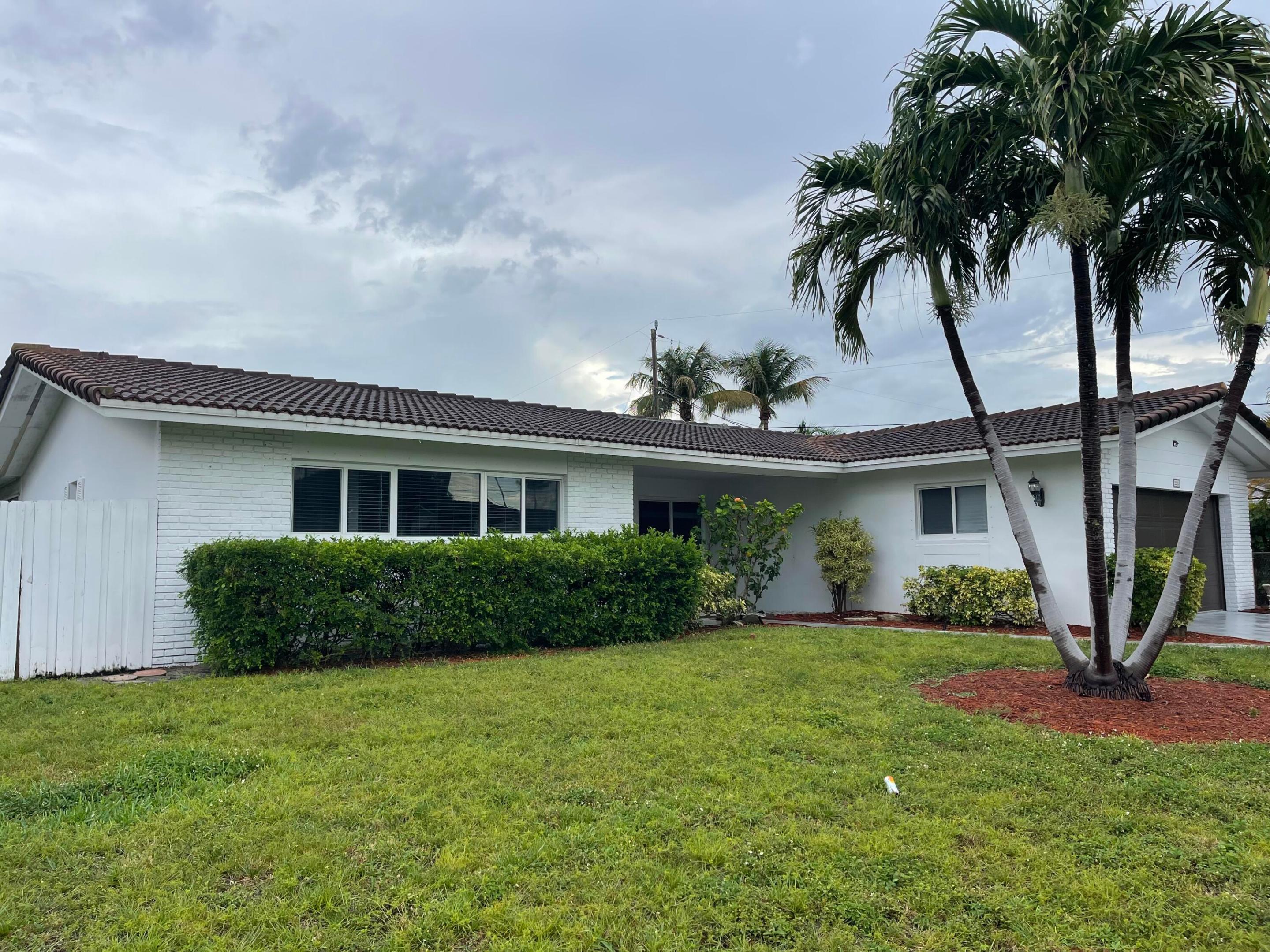 Welcome to this charming 3-bedroom, 2-bathroom single-family residence located near the Yacht Club in the desirable Venetian Isles  in Lighthouse Point.  This thoughtfully designed one-story home offers 1,799 square feet, updated kitchen, impact windows, providing comfortable room for everyday living and entertaining. The two-car garage offers convenient storage and vehicle protection. Whether you're seeking a practical residence in an established community or looking for your next place to call home, this property presents an excellent opportunity to settle into Lighthouse Point living. N Federal to NE 39th St left, a sign to Yacht Cub to 40th street, left to home