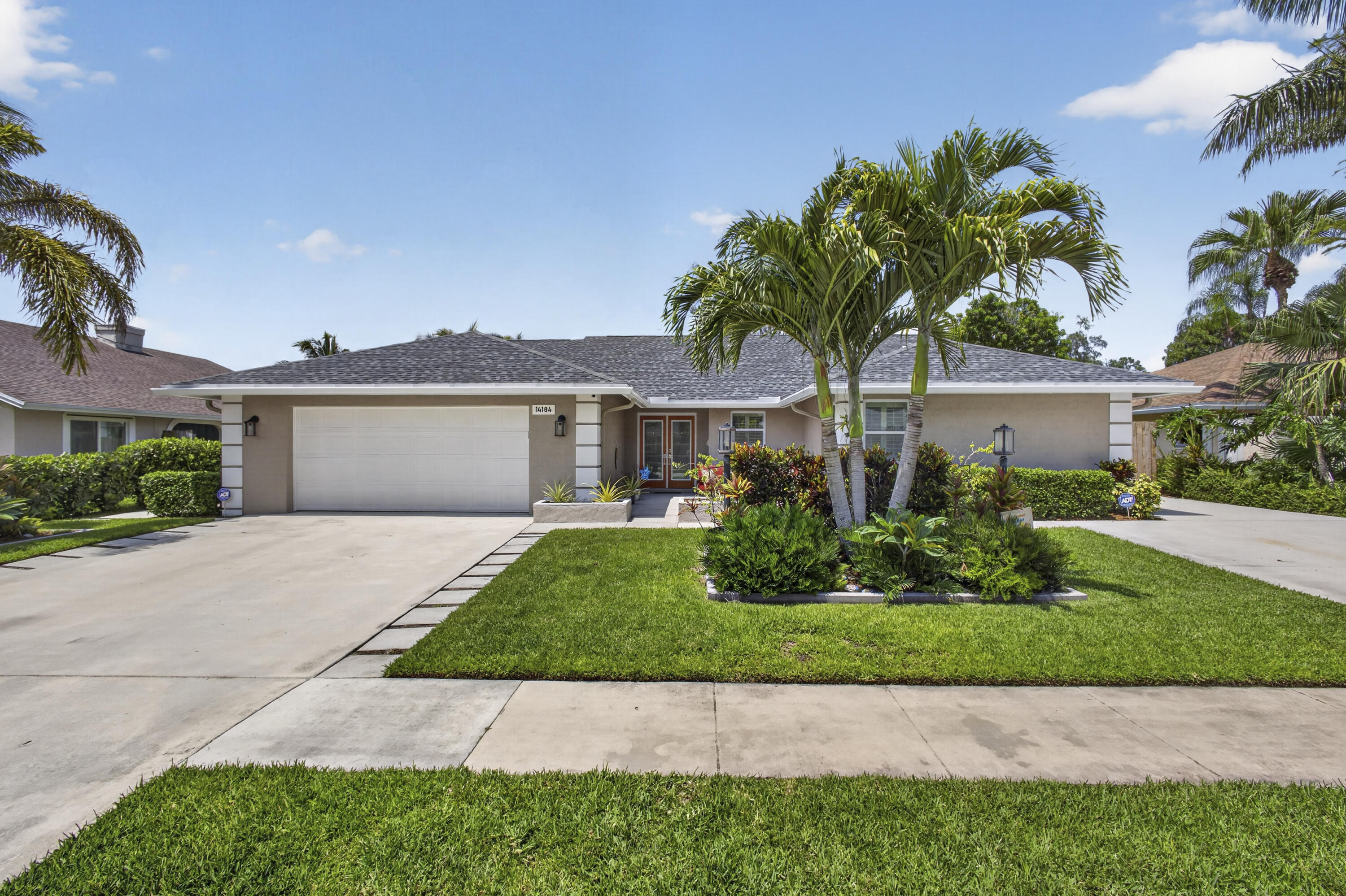 Move right into this beautifully remodeled 4-bedroom, 2-bath home in the heart of Wellington! Featuring an open-concept design with walls removed between the kitchen and family room, this home boasts a stunning remodeled kitchen with a large island, double ovens, custom soft-close cabinetry, and newer appliances. Fresh interior and exterior paint and elegant plantation shutters complement the lovely design. Major updates include a NEW 2026 roof, A/C (2022), water heater (2019), Impact windows and doors provide added security and peace of mind. The huge fenced backyard is a private oasis with a shaded area and plenty of room for a pool. Two sheds on concrete slabs stay with the property, offering ample storage for tools and toys. There is even an RV/boat pad and a second driveway with  parking for up to 10 vehicles. Conveniently located near A-rated schools, shopping, dining, and Wellington's world-renowned equestrian venues. Nothing to do but move in!