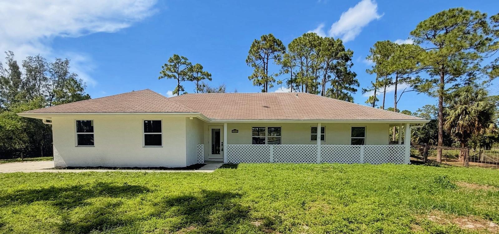 Welcome to this beautifully renovated single-family home situated on 1.29 acres of fully fenced land with NO HOA! Built in 2000, this exceptional property offers the perfect combination of modern upgrades, privacy, and plenty of room for your lifestyle needs. The home features impact windows and doors throughout, a brand-new A/C system with a Nest thermostat, a new water filtration system with water pump, vaulted ceilings, recessed lighting, and updated ceiling fans. The beautifully renovated kitchen showcases quartz countertops, stainless-steel appliances, and modern finishes, while the brand-new bathrooms provide comfort and style. Step outside and enjoy the freedom of acreage living with a long driveway, dual entrance gates, mature trees, and plenty of space for RVs, boats, trailers, work vehicles, horses, cattle, and more. The spacious backyard features pavers and is fully fenced for added privacy and security.  A standout feature is the detached shed with a brand-new metal roof, offering endless possibilities. Use it as horse stalls, space for pets or livestock, a workshop, storage area, or even convert it into a garage.