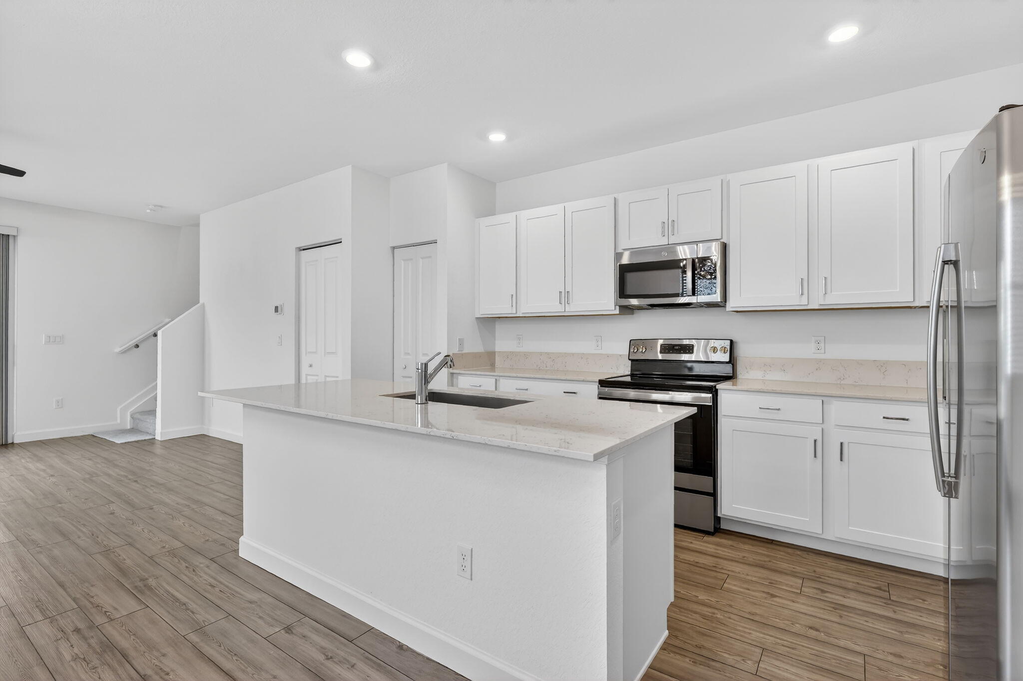GORGEOUS CORNER UNIT W/ OPEN FLOOR PLAN & PLENTY OF WINDOWS WHICH BRING IN AN ABUNDANCE OF NATURAL LIGHT. ISLAND KITCHEN W/ STAINLESS STEEL APPLIANCES & WHITE CABINETRY OPENS UP TO SPACIOUS DINING/FAMILY ROOM, WOOD DESIGN TILE IN LIVING AREAS AND DESIGNER FANS W/ LIGHT IN ALL ROOMS. LOUVERED BLINDS ON ALL WINDOWS. DEN ON 1ST FLOOR CAN BE 4TH BEDROOM/OFFICE. SLIDING DOORS OPEN TO YARD FOR OUTDOOR RELAXATION. ALL BEDROOMS ARE UPSTAIRS FOR PRIVACY. PRIMARY BEDROOM HAS OVERSIZED WALK-IN CLOSET. 2ND & 3RD BEDROOM CONNECT TO JACK & JILL BATHROOM W/ TUB -SHOWER COMBO. W/D UPSTAIRS FOR EASE OF USE. IMPACT WINDOWS THROUGHOUT AND COATED GARAGE FLOOR. GREAT COMMUNITY CLOSE TO ALL THINGS BEAUTIFUL IN PORT ST. LUCIE