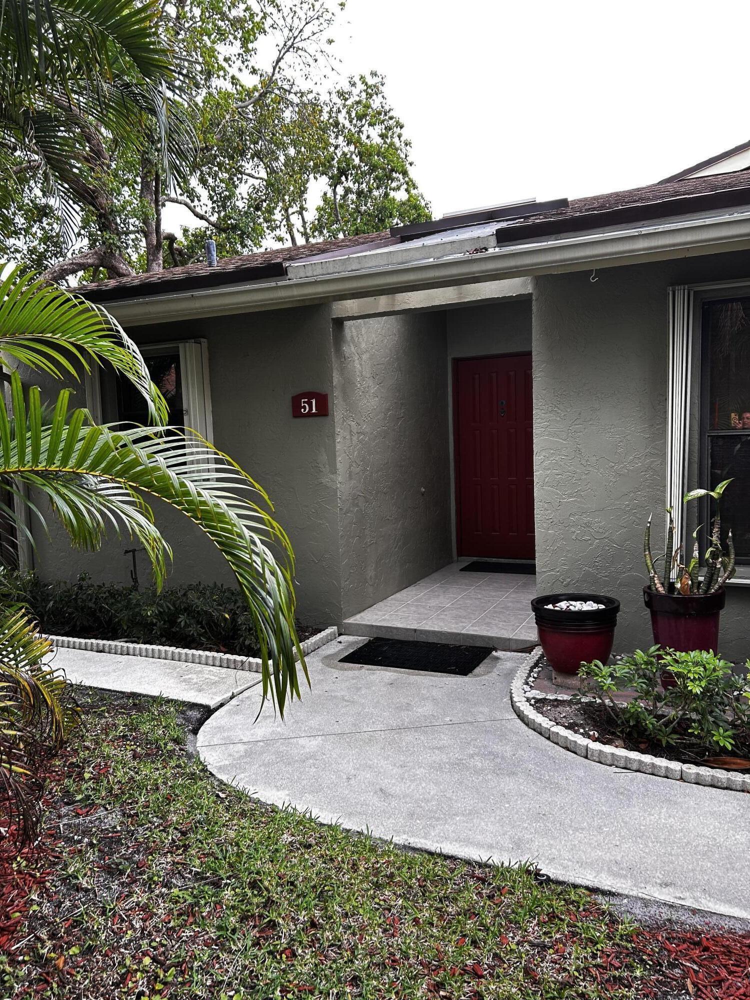 Charming move-in ready 2BR/2BA home in the desirable Willowbrook community of Boynton Beach! This well-maintained residence features a newer roof, wood-look tile flooring, and beautifully updated bathroom vanities. The kitchen offers the only eat-in breakfast bar in the community. Spacious primary suite includes a walk-in closet. Enjoy seamless indoor-outdoor living with 4 access points to your private, fenced-in courtyard, perfect for relaxing and entertaining. Complete hurricane protection with accordion shutters. Located in a quiet neighborhood just steps from the community pool, mailbox, and your 2 assigned parking spots. Association approval and interview required, 2 pets max under 40 lbs, 670 minimum credit score. Association is responsible for roof replacement and building exterior.