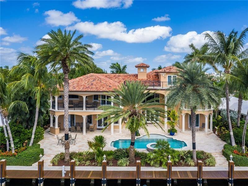 Enjoy this 10,000+ sqft custom built timeless beauty in Coral Ridge with 100' dock, ideally situated 3rd property from the point for more protected dockage. Relish the outdoors from the covered balconies with gorgeous cypress wood ceilings, glorious marble patios & the expansive rooftop terrace for Views of the Intracoastal & Birch State Park. This like-new fortress with 5 spacious en suite bedrooms was meticulously constructed with poured concrete plus steel rebar every few inches. Marvel at the extensive intricate crown moldings, tray ceilings, cove lighting & attention to detail. Of course there is a scrumptious movie theater room & a well-appointed gym for indoor pursuits. The feeling of comfortable luxury exuded by this home cannot be beat! View the supplement for more details.