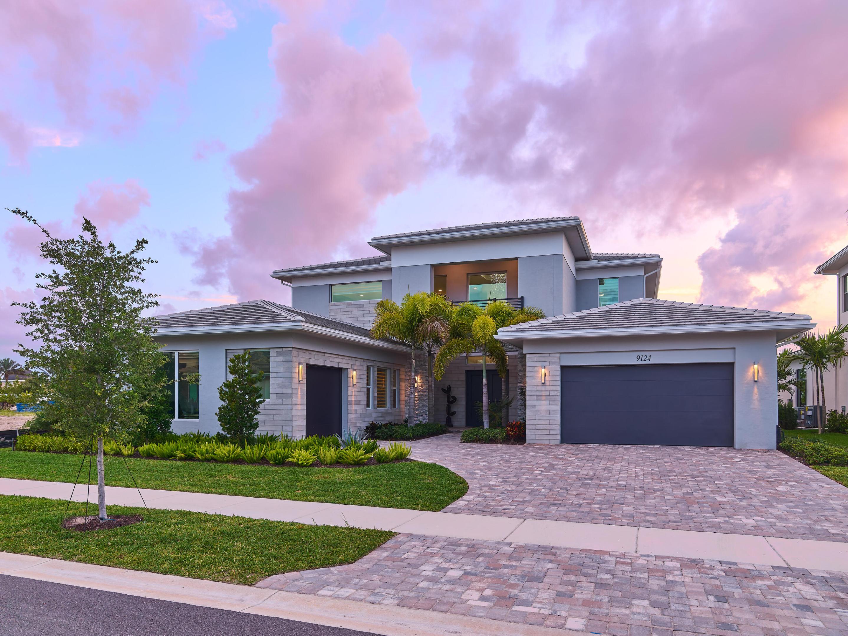 Brand-new and never lived in, this breathtaking Dominica model in Avenir's Coral Isles offers over $400,000 in upgrades across over 5,300 square feet of luxury living space with designer finishes throughout. Featuring 5 bedrooms, 6 full baths, 1 half bath, a clubroom, expansive loft, and 3-car garage, this move-in ready home blends elegance, comfort, and modern sophistication in one extraordinary package. The exquisite developer enhancements include a $135,000 upgraded exterior including a gorgeous stone façade, and over $225,000 in designer interior finishes featuring custom flooring, dramatic stair design, wallpaper accents, handmade millwork wall units, premium lighting systems, custom window treatments, and professionally designed primary closets. The gourmet kitchen is truly  spectacular, anchored by a stunning 14-foot quartz island and equipped with a Sub-Zero refrigerator/freezer, Wolf double ovens, Wolf microwave, and Wolf 6-burner red knob professional cooktop. Plus high-gloss cabinetry, polished porcelain tile flooring, custom lighting, and an open-concept design. The expansive clubroom/family room offers custom handmade built-ins, designer lighting, and an 85-inch TV, while the oversized loft offers flexibility for a gym, office, media room, or play space. The first-floor primary suite offers a spacious sitting area, custom his-and-her walk-in closets with integrated lighting, and a spa-inspired bathroom with oversized seamless shower, freestanding soaking tub, dual vanities, and designer tile finishes. The covered lanai overlooks a spacious & private garden with ample room to build a custom pool and outdoor kitchen, with plumbing already installed. Located in the award-winning community of Avenir, residents enjoy a spectacular 16,000 sq ft clubhouse, resort-style pool, lap pool, fitness center, tennis courts, pickleball courts, walking trails, restaurants, shops, golf cart-friendly streets, and year-round community events.