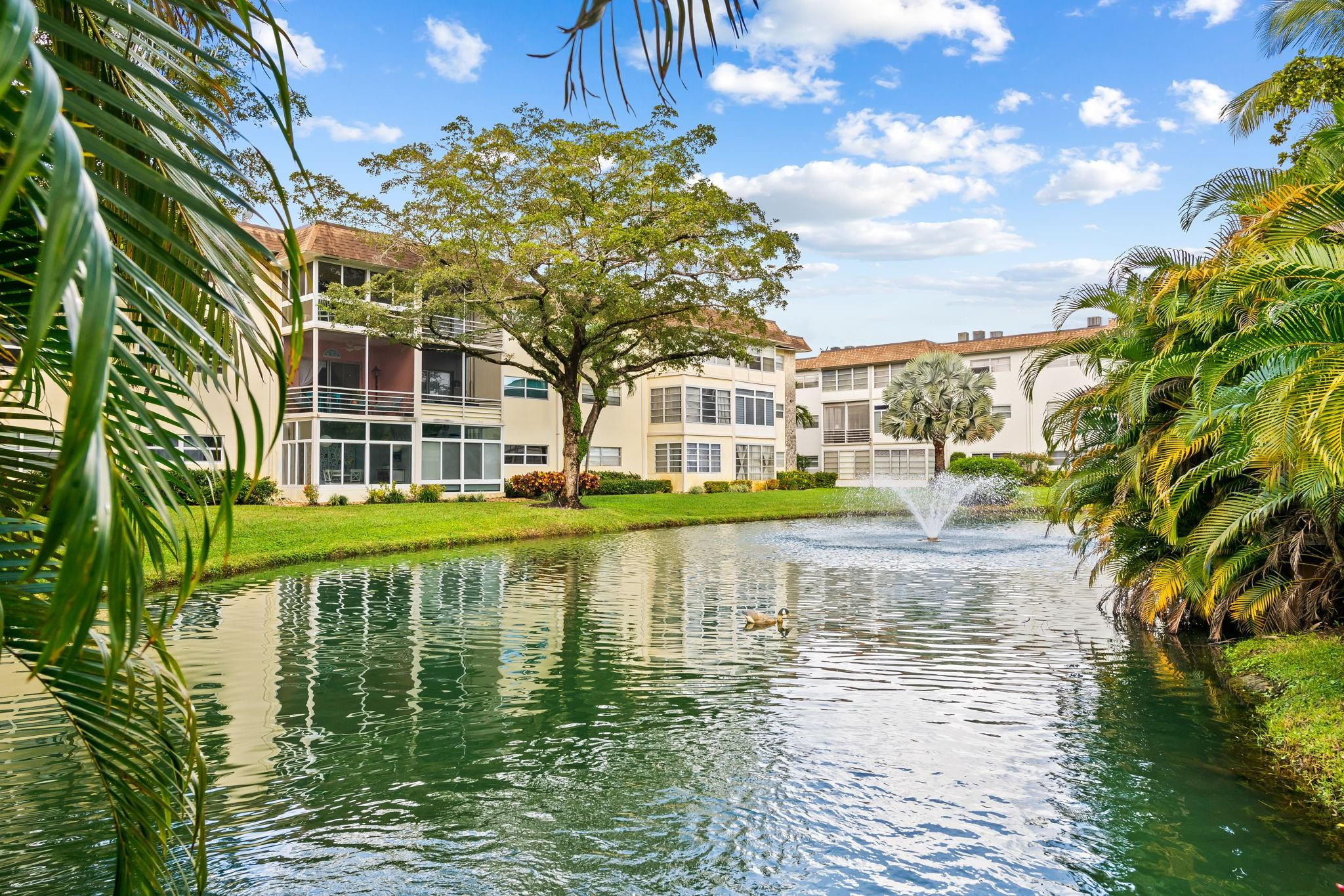 Turnkey, fully furnished 2-bedroom, 2-bath condo in the sought-after 55+ community of Hawaiian Gardens. Move right in and enjoy a renovated kitchen and baths featuring wood cabinetry, granite countertops, stainless steel appliances, and tile backsplash. The open living and dining area with wood floors leads to a glass-enclosed porch overlooking the pond and pool. Bedrooms offer hurricane-impact windows, tile flooring, and ample closet space. Updates include 2026 building paint, 2024 roof, 2023 elevator, 2020 water heater, and updated plumbing. Community amenities include pools, fitness center, library, billiards, shuffleboard, picnic area, laundry, and storage. Rentals allowed with restrictions. 50-year certification and SIRS completed!