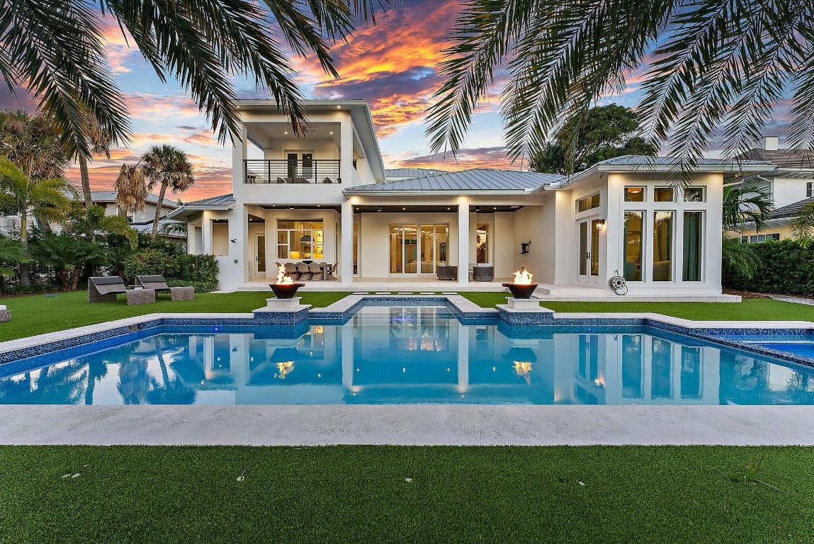 SPECTACULAR 2021 Waterfront home in Hidden Key, one of the Northern Palm Beaches most exquisite enclaves.  This Modern 5 BR estate home offers a serene coastal aesthetic w/ impeccable finishes throughout. Every detail has been finely curated to create the perfect Florida lifestyle, blending indoor + outdoor living.  A grand circular drive and double door entry welcome you to an oversized living area with beamed ceilings and full wall sliders that open to a grand loggia.  The adjacent chef's kitchen with Miele appliances, a breakfast area + huge island adds perfect space for intimate or grand entertaining.  A massive Owners suite offers privacy + serenity, graced by a windowed seating area, dual custom closets and a spa  bath.  There is a spacious second bedroom on the lower floor as well as a large office. The upper level features three huge additional bedrooms, complemented by spacious balconies, custom closets and luxe baths.  Smart home technology throughout the home provides additional comfort + security.   The outdoor area is exceptional - a true tropical Oasis.  A spacious covered lanai w/ marble flooring overlooks the stunning pool + spa area, surrounded by enchanting greenery and generous lawn space.  A sleek + modern summer kitchen + alfresco dining area complete this outdoor haven.  The canal behind this home can accommodate a dock for up to a 30' boat, with easy access to Little Lake Worth and the nearby Intracoastal Waterway.  A great opportunity to own one of the Newest homes in North Palm Beach!  Close to the finest shopping, dining, golf, educational and cultural venues.   The newly renovated North Palm Beach Country Club, featuring a signature Jack Nicklaus course, tennis, Olympic size pool and the Club House restaurant is less than a mile away.   A fabulous home and lifestyle await you!