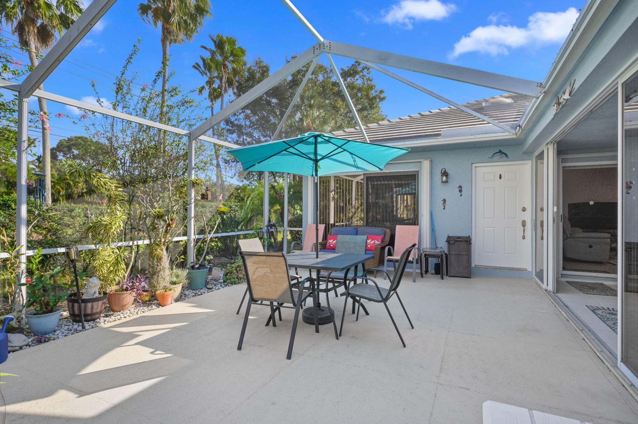 Welcome to this well-maintained 2-bedroom and 2-bath Villa offering 1,152 sq. ft. of comfortable living space in a desirable, amenity-rich community. Included with sale: Two patio sofas, table, chairs, umbrella, grill & utility cabinet with shelves. The open floor plan features wood and ceramic tile flooring throughout the main living areas, crown molding, and a split bedroom layout that provides privacy for owners and guests alike. The kitchen offers Corian countertops, stainless steel appliances, a counter bar, and an open layout, perfect for everyday living and entertaining. Both bedrooms feature large closets and abundant storage, including a dedicated storage room with a workbench. Enjoy year-round comfort in the enclosed patio with impact glass sliders, plus a spacious open patio ideal for outdoor relaxation. Additional features include accordion hurricane shutters and numerous system upgrades: AC and water heater replaced in 2022, washer replaced in 2024, and water conditioner, softener, and reverse osmosis system included. The HOA provides exceptional value, covering roof maintenance, exterior painting, lawn care, cable, internet, and access to community amenities including a recreational pool and tennis courts. Conveniently located just minutes from shopping, dining, and medical facilities in St. Lucie West, with quick access to I-95 and major highways. A low-maintenance lifestyle opportunity you won't want to miss.