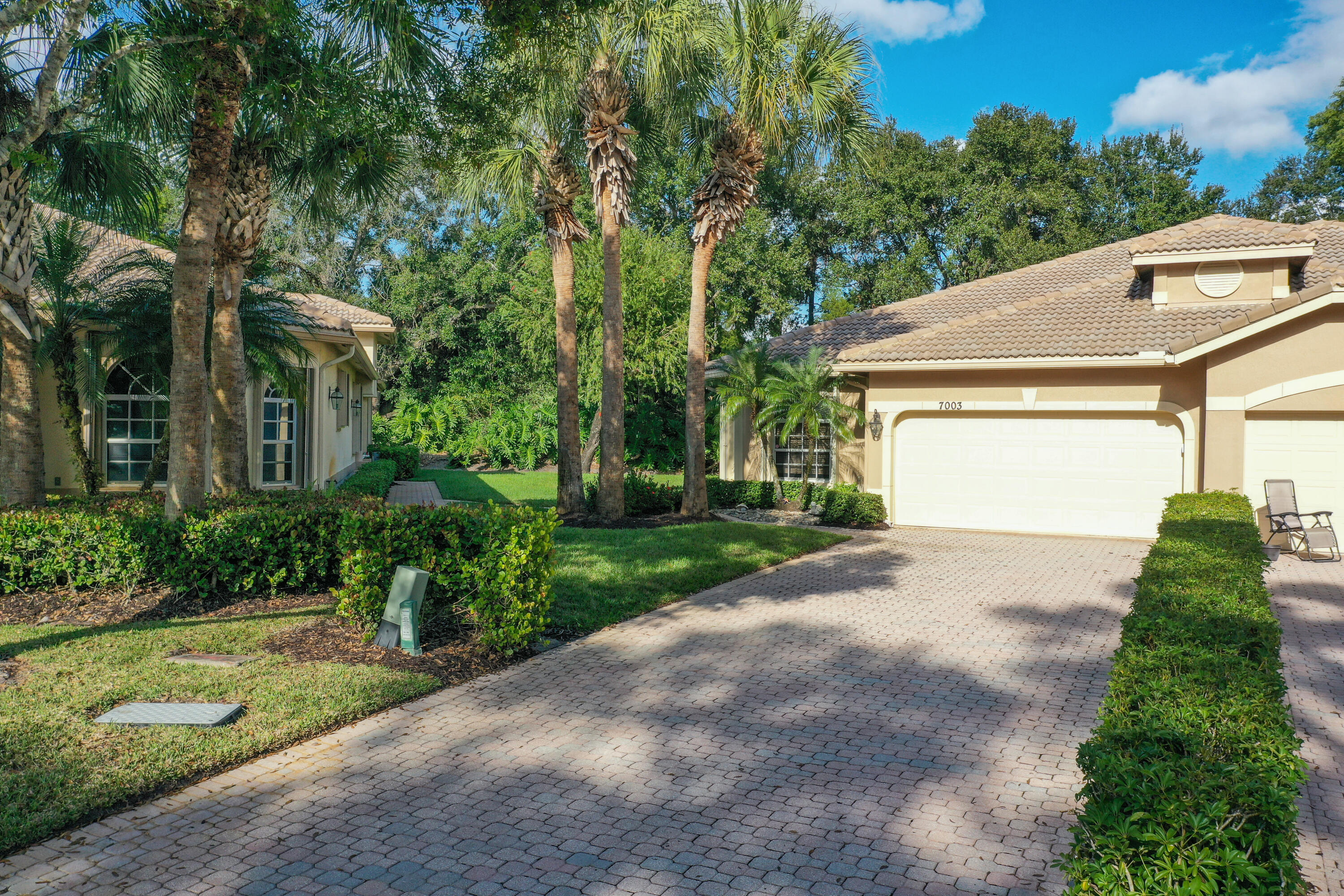 Beautifully decorated Villa offers 2/2 with DEN and 2 car garage nestled in the highly sought after PGA Community Willow Pines.  This open spacious floor plan boasts an updated kitchen with 42-inch white cabinets, granite counter and glass backsplash. SS appliances. Crown molding and tray ceilings are accented with professional designer's paint throughout.   Private covered screened Lanai with view of preserve with tranquil feel. New Accordion Hurricane Shutters total. Offered TURNKEY ready to enjoy florida living (den sofa, lv room recliners do not convey)  Cable, internet and lawn care included.  Willow Pines has its own COMMUNITY POOL,  access to the ''Island Club'' Pool and amenities which include fitness center, billiards room, card rooms, library, craft rooms, tennis and pickleball. PGA Golf membership is available; all are welcome to play and pay as you wish. PGA Community has easy access to I Restaurants, shopping, medical, Mets Stadium.