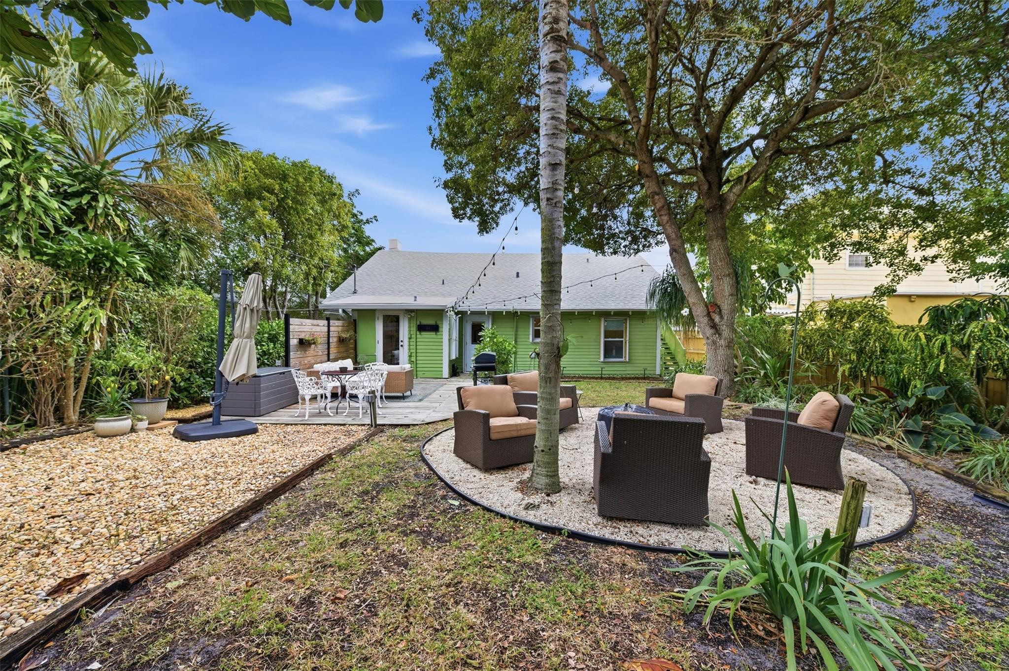 Charming restored 1920s two-story historic home just one block from the Intracoastal and walking distance to downtown Lake Worth, with the beach a short stroll or bike ride away. Oversized front porch opens to a bright interior with original hardwood floors, preserved moldings, cozy dining room fireplace, formal entry, renovated kitchen with natural gas range and breakfast area, and indoor laundry. Upstairs features a spacious primary suite with sitting area/office, large bath, abundant storage, and private exterior entrance. Downstairs offers 3 bedrooms and 1 full bath, ideal for family or work-from-home. Fully fenced oversized yard with irrigation, shed with electric, and room for pool, RV/boat, or ADU. New roof (2021) and updated electric.