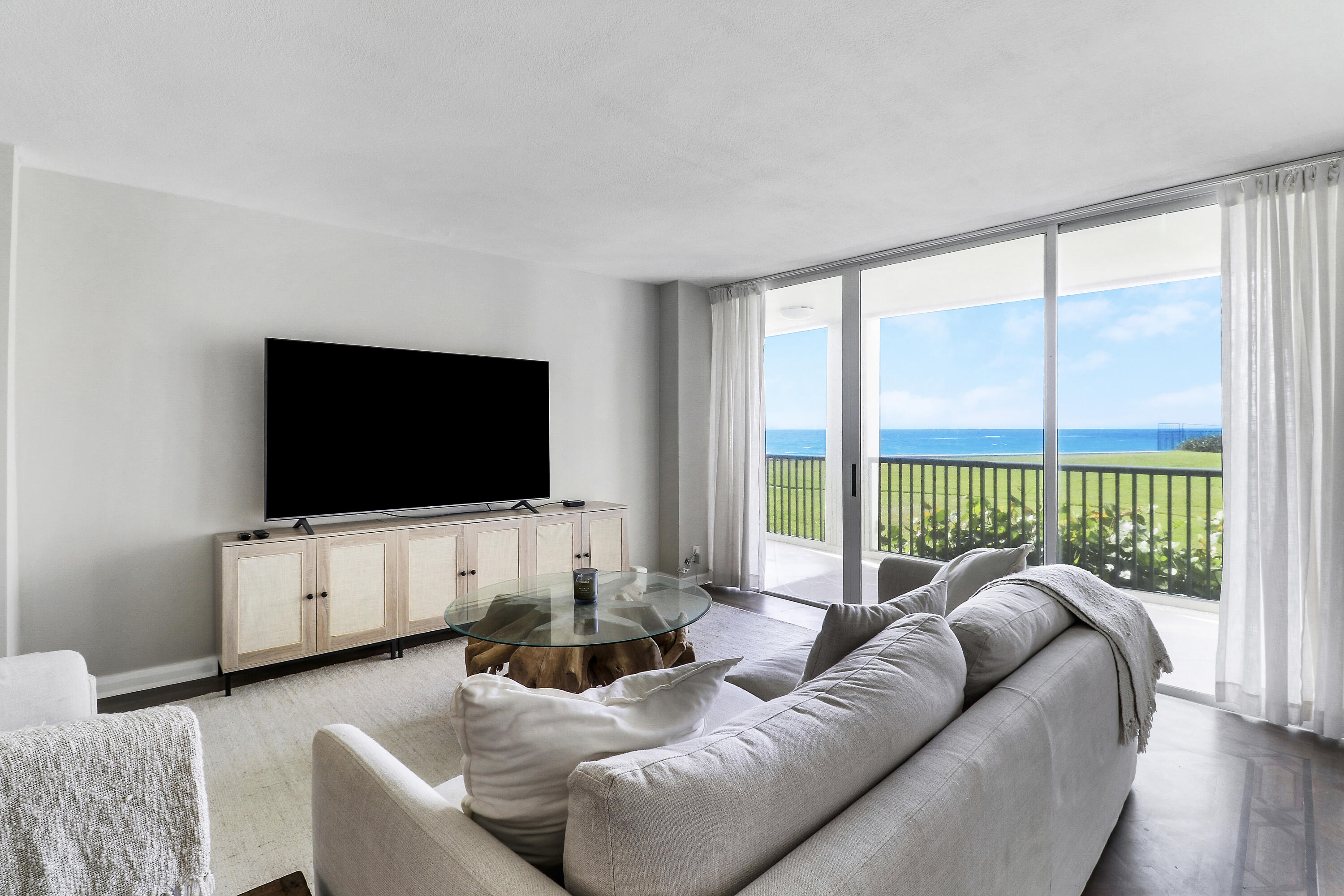 Wake up to sweeping ocean views and the sound of the waves from this beautifully furnished 2-bed, 2-bath residence at the Sea Dunes on Singer Island. Elevated above the lobby level and ideally positioned to capture direct ocean views, this coastal retreat offers an effortless blend of relaxed luxury and everyday comfort. Floor-to-ceiling sliders fill the living spaces with natural light and seamlessly connect the interior to the expansive beachfront setting beyond.  Enjoy private beach access just steps away, along with resort-style amenities including a pool, fitness center, gated entry, and on-site management. Offered fully furnished, this inviting seaside residence is ideal for those seeking an elevated coastal lifestyle with the ease, comfort, and tranquility of beachfront living.