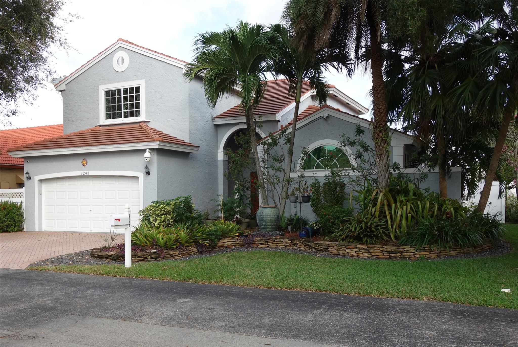 Large 4 bedroom 2.5 bath home in a gated community. Features include remodeled kitchen, tile floors, all impact windows and doors, 2 car garage, extra large covered patio and much more. Located in Lake Pointe Estates a gated waterfront community which offers tennis and a large heated pool on the waterfront. The large master bedroom is on the 1st flr and has a seating area, 2 walk in closets, double vanity, whirlpool tub and stand alone shower. Upstairs you will find three bedrooms (one has a large walk-in closet) remodeled bathroom and a sitting area on the landing. The outside of the home is lushly landscaped but done in a way that is easily maintained. The home also comes with a second refrigerator, generator and large propane tank. Dollar per square foot makes this home a great value.