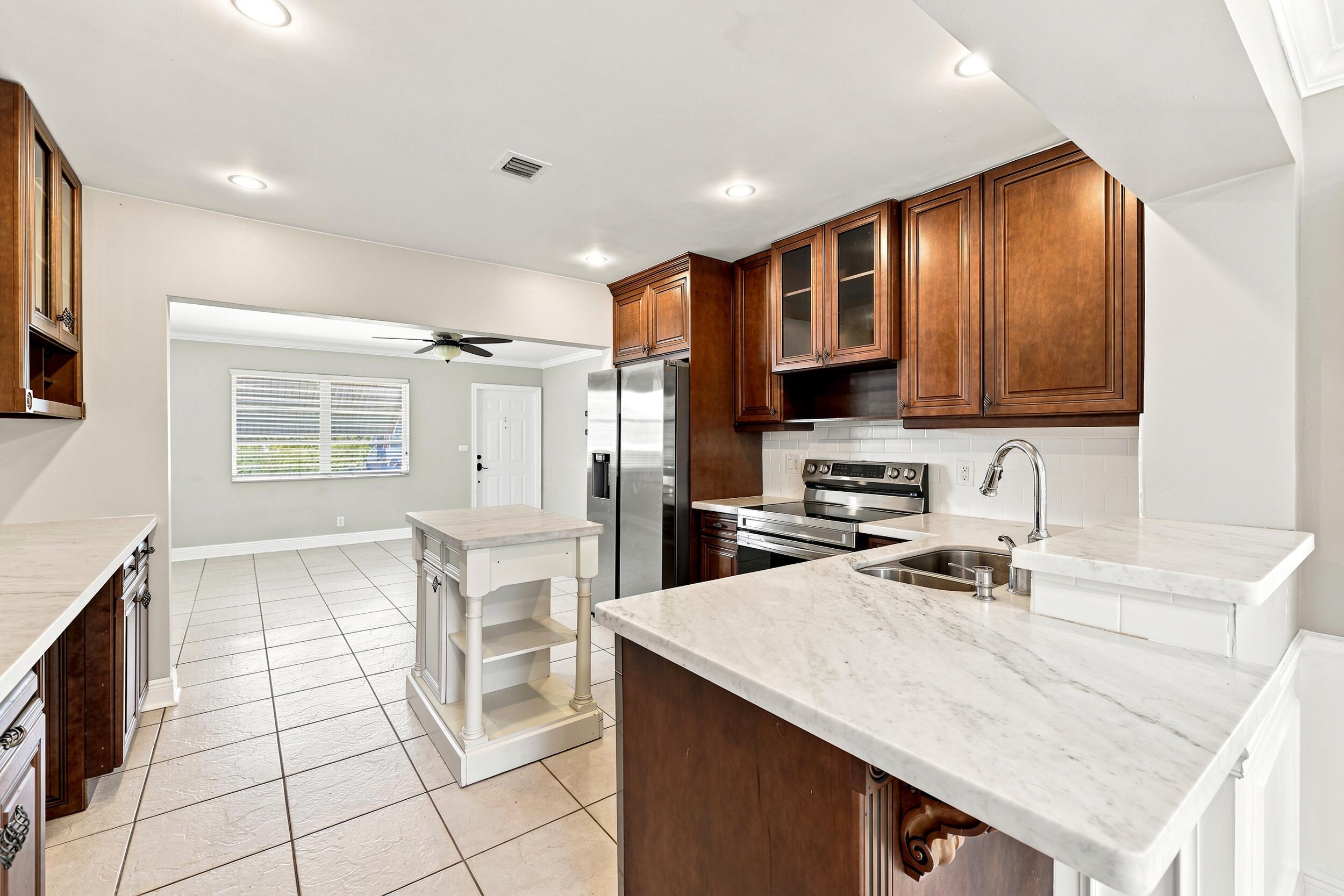 Welcome to this charming single-story home in the desirable Tamarac Lakes community! This inviting 2-bedroom, 1-bath residence features a bright, functional layout and a kitchen with brand-new stainless steel appliances. Step outside to enjoy a private fenced backyard complete with a spacious back patio and outdoor shower, perfect for embracing the Florida lifestyle. Enjoy low HOA fees in this pet-friendly community, along with excellent amenities including a pool, clubhouse, shuffleboard courts, and picnic area. Ideally situated near I-95, shopping, dining, parks, beautiful beaches, and the airport, this home offers the perfect blend of comfort, convenience, and Florida living.
