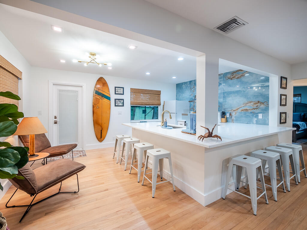 Welcome to your cozy retreat in the heart of Lake Worth Beach! This charming 2-bedroom, 1-bathroom single-family home is a perfect oasis for those seeking both comfort and convenience. Nestled in a tranquil neighborhood, this property boasts a natural bamboo filled backyard, creating an ambiance where you can relax and entertain guests around the fire pit. Location is key, and this home offers proximity to some of Lake Worth Beach's finest hangouts. You're just a stone's throw away from the beautiful beach, the intracoastal waters, and a great golf course. When you're not out enjoying the beach, you'll appreciate the convenience of being within walking distance from downtown, where you can explore a variety of restaurants, shops, and entertainment options.  Inside, you are welcomed with an open layout, providing a spacious and airy feel. You'll be greeted by recessed lighting and trendy fixtures that add a touch of elegance to the space. Notable upgrades include a new air conditioner, a recently replaced roof, and hurricane impact protection, providing peace of mind during Florida's stormy seasons. The refurbished wood floors and window treatments add character and style to the space. The living room flows seamlessly into the remodeled kitchen, which features a huge quartz countertop, and a stunning feature accent wall. The stacked bedrooms are adjacent to the updated bathroom. The washer and dryer are located in the detached garage. Outdoors, you'll find a fenced-in yard, perfect for privacy and security. This property truly offers the best of Lake Worth Beach living. Don't miss the opportunity to make this your dream home and schedule your showing today!