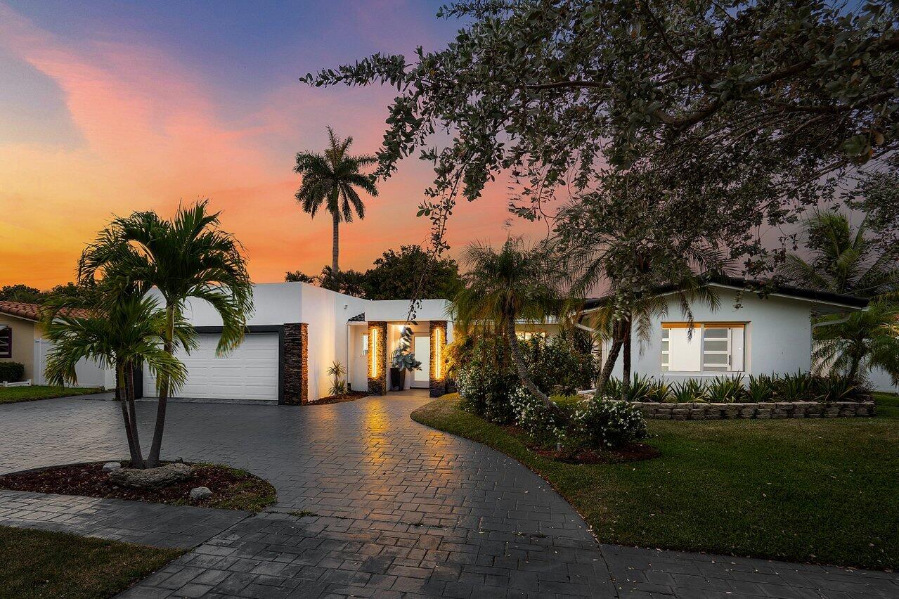 Just 10 minutes from the beach, this sleek 4BD/3BA home blends modern design with coastal charm. With many high-end upgrades including impact windows and soaring 9-ft ceilings in the primary suite. The open-concept kitchen impresses with quartz counters, a statement island, and custom cabinetry. Spa-inspired baths feature floating vanities, LED mirrors, and a luxurious soaking tub. Outside, unwind by the heated pool, host under the covered gazebo with built-in BBQ, or relax by the electric fireplace. The 4th bedroom flexes perfectly as a home office or den.
