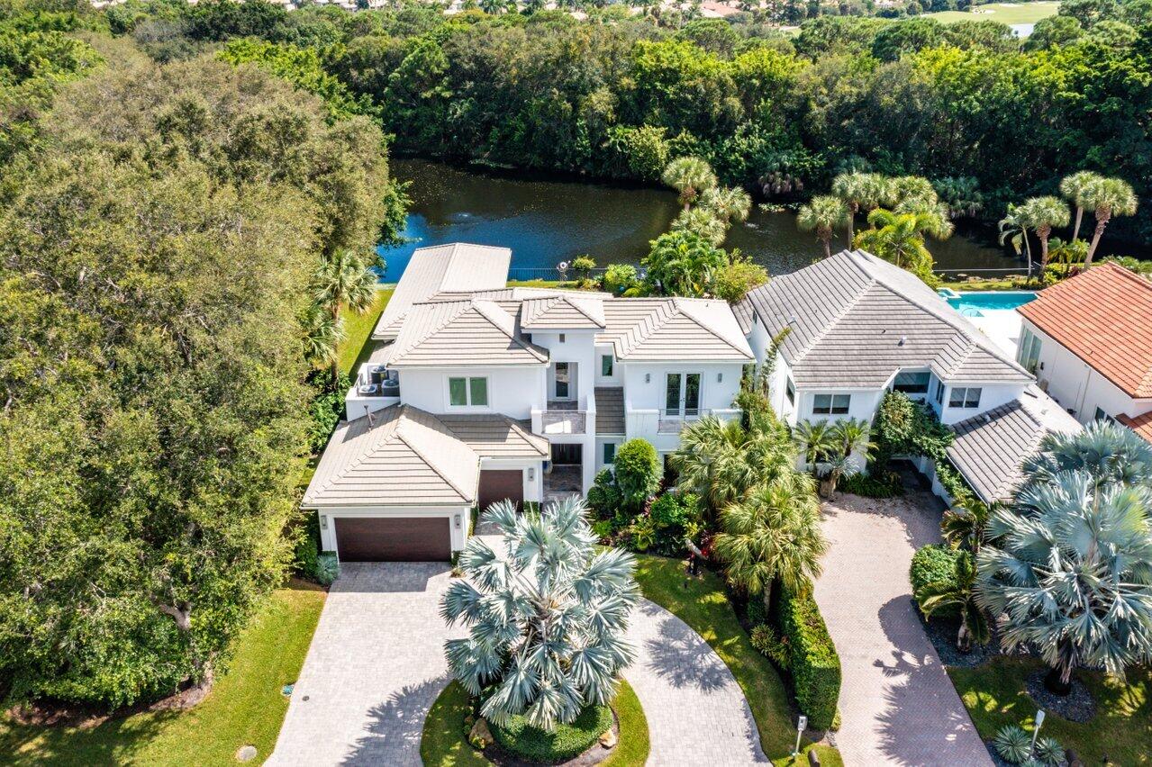 Stunning custom estate with serene lake view nestled in the exclusive Frenchmans Creek Beach and Country Club. 5 bedrooms, 4.5 baths plus office home newly built in 2014 with a contemporary design aesthetic way ahead of its time. This fabulous home shows like it was just completed. Light and bright finishes and easy living inside and out. Relaxing views of the lake and custom heated pool offer the perfect space for entertaining. The main floor luxurious primary suite offers dual custom fitted closets, french doors to the pool deck, a spa like modern bathroom with luxurious finishes & fixtures,  tub and an office / bonus room that can be accessed from the primary suite or from the main part of the house. With 3 bedrooms on main floor and 2 VIP suites upstairs and a large loft & access to terraces your guests may never want to leave. The kitchen is a chefs dream with immaculate marble countertops, custom cabinetry, Thermador appliances, wine fridge, and more. Other features include complete impact glass, automatic screens and cypress ceilings on outdoor lanai, travertine patio pavers, wet bar in loft space, and dry bar on main floor.  Residences at Frenchman's Creek enjoy the ultimate concierge lifestyle with resort amenities including an exclusive and private Beach Club directly on the Atlantic Ocean, extraordinary security, and navigable waterways for those interested in boating and deep-water sports. The secret of Frenchman's Creek success is found in the impeccable service delivered by exceptional staff graciously catering to all residences' needs with casual elegance, luxury and grace.  Call for your private tour today!