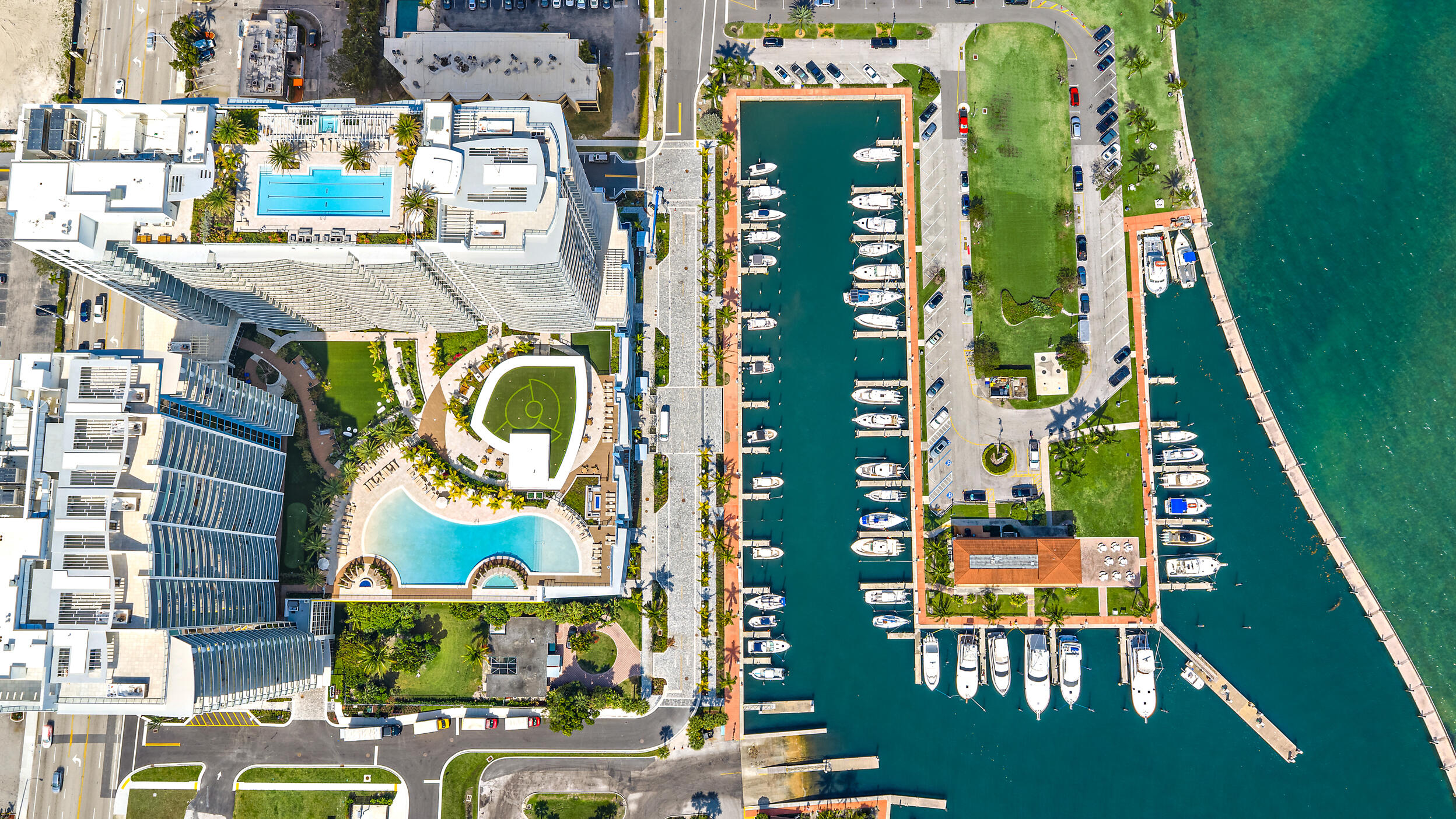 Perched on the 15th floor, this brand-new waterfront residence at Nautilus 220 delivers sweeping Atlantic, Intracoastal, and sunset views—at one of the best values currently available in the building. This 2-bedroom, 2.5-bath home features 10-foot ceilings, a clean open layout, European lighter oak flooring, custom cabinetry, quartz surfaces, and spa-style baths. The chef's kitchen is equipped with Miele appliances and a dramatic quartz waterfall island, while the North, Northeast -facing terrace captures sunrise-to-sunset views over the ICW, Singer Island AND the Atlantic ocean. The resort-style pool deck on the 6th AND top floor are AMAZING East-West exposure. Includes two garage spaces (one EV-ready) and private storage. Nautilus 220 delivers a true resort lifestyle with over 1 acre of elevated amenities, including a pool, spa, firepit lounges, and outdoor entertaining areas, plus a rooftop lap pool with panoramic water views. Residents enjoy a full fitness center, various grill stations, sauna and steam rooms, bowling alley, theater, golf simulator, concierge services, private beach access on Singer Island, and on-site waterfront dining by David Burke with some of the best steaks in Palm Beach County.