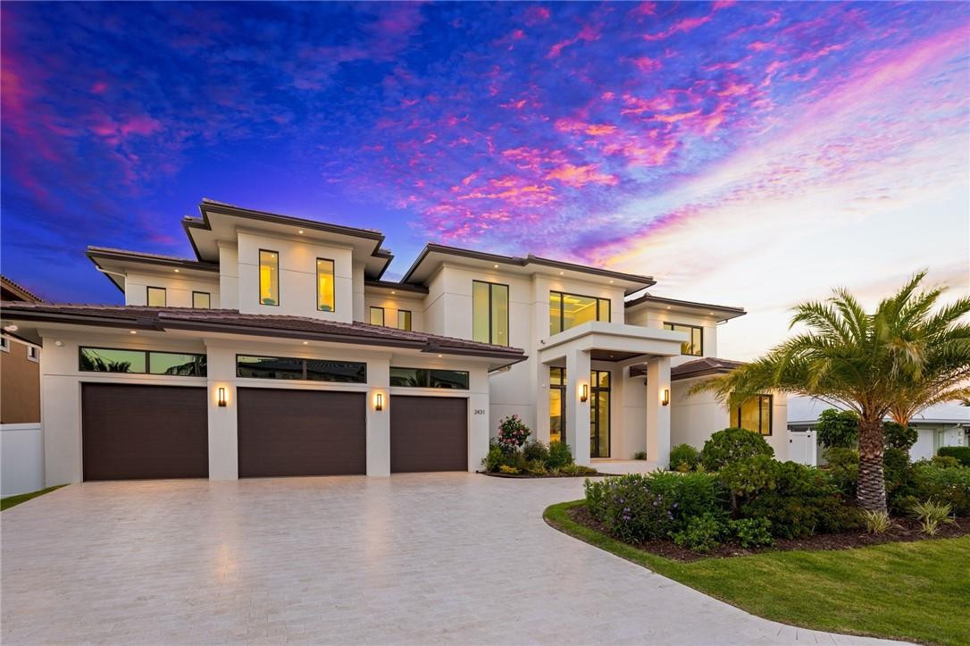 Exceptional waterfront estate with immaculate contemporary finishes designed by Zahn Builders, boasting 100+ feet on the Captain Knight Bayou. Magnificent natural light flows through the home’s double door entry and glass-encased rooms with open views of the water. Master quarters feature lavish spa-like baths, his/her closets, and a private waterfront balcony. Features include a custom kitchen with top-of-the-line appliances, separate exercise room, theatre room, elevator, exquisite floating staircase, and 3 car garage. Entertain family and friends in the expansive outdoor area with resort-style pool, 3 covered lanai's, summer kitchen, and cabana. Boater's dream with yacht dock and easy access to Hillsboro inlet.