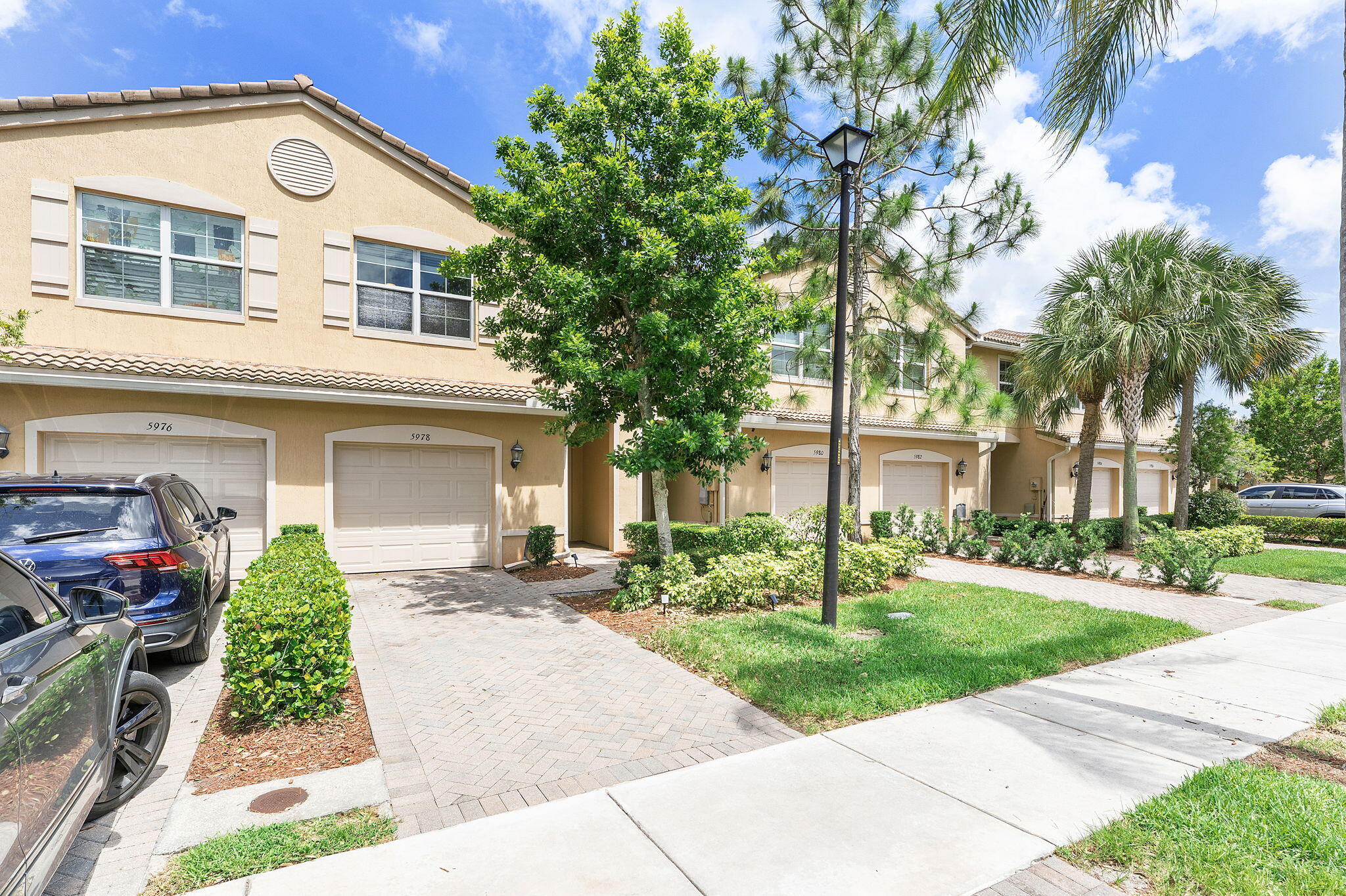 Beautifully upgraded luxury townhome featuring 3 bedrooms and 2.5 bathrooms, including a spacious primary suite with a separate soaking tub and walk-in shower. This elegant residence showcases numerous builder upgrades including crown molding, enhanced interior lighting, granite countertops, and upgraded shower tile finishes. The entire home has been updated with luxury vinyl flooring throughout. The modern kitchen is equipped with stainless steel appliances, including a new refrigerator and new washer/dryer. The seller spared no expense by extending the patio pavers and adding privacy hedges, creating the perfect outdoor retreat. Additional highlights include a 1-car garage, paver driveway with parking for two vehicles, and a prewired Level 2 EV charger. Residents enjoy access to  a stunning lakefront clubhouse featuring a professionally equipped fitness center, card room, great room, and warming kitchen for private events. Resort-style amenities include a heated lakefront pool and spa, children's play area, oversized tot lot, basketball court, and scenic promenade with gazebos, fountains, benches, trellises, and picturesque lake views. An ideal primary residence or investment opportunity with low monthly HOA fees, conveniently located in the desirable Colony Reserve community near major shopping, grocery stores, restaurants, banks, and more.