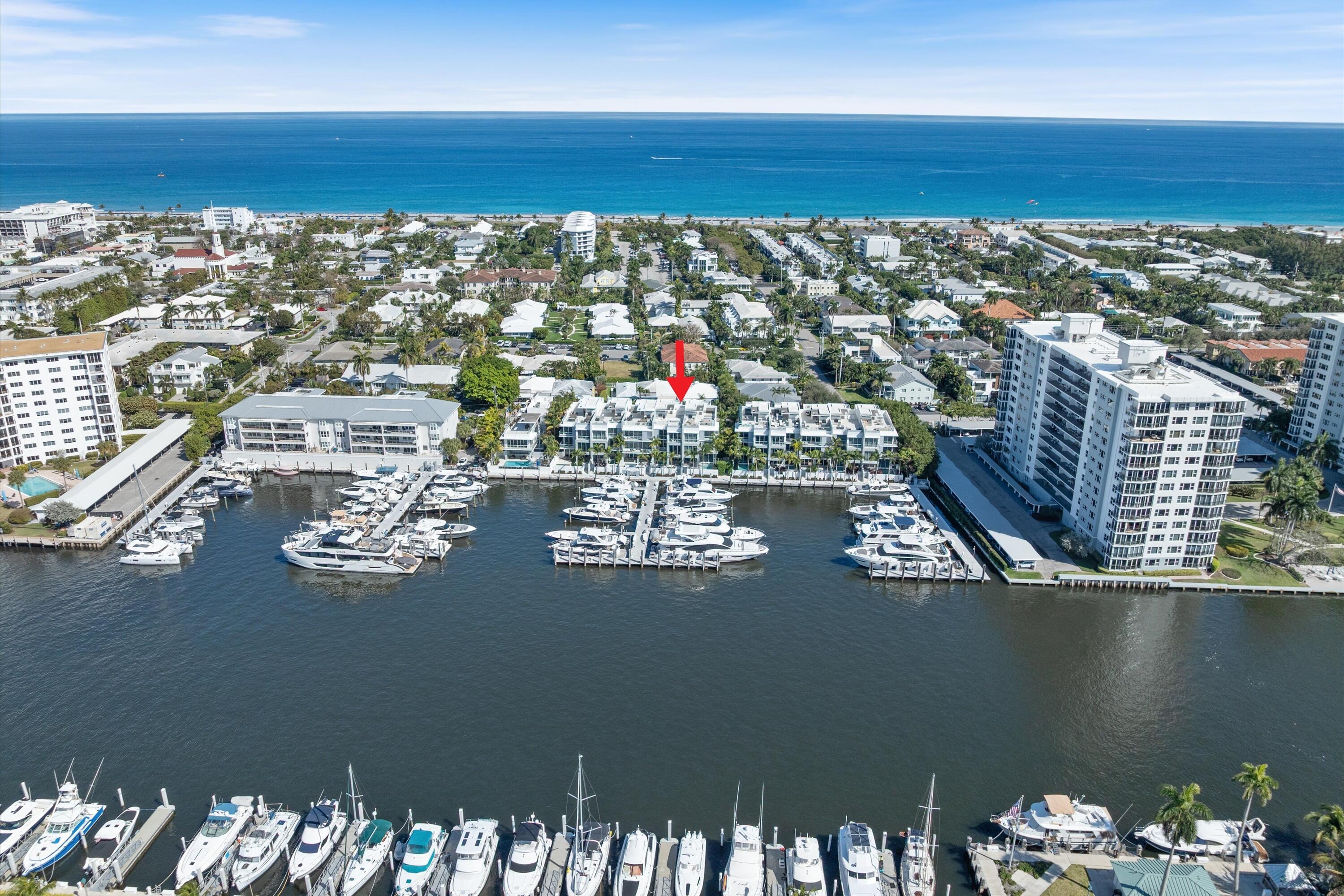 Experience the pinnacle of waterfront luxury in this sophisticated four-story townhome, nestled within the exclusive enclave of The Seagate Yacht Club Residences—a private community of only ten homes perched directly on the Intracoastal Waterway. Built in 2016, this contemporary residence seamlessly blends modern elegance and coastal sophistication, capturing the essence of South Florida's premier lifestyle. Just three blocks from the beach and Atlantic Avenue's fine dining, boutique shopping, and vibrant nightlife, it offers an exceptional balance of privacy, design, and location.
 
From the moment you arrive, the home's impeccable curb appeal sets the tone. Manicured landscaping, a decorative paver driveway, and a gated entry introduce a sense of exclusivity and refined style. Inside, volume ceilings, designer lighting, and wood-look tile flooring throughout establish a cohesive atmosphere of understated contemporary luxury. Expansive walls of glass frame panoramic Intracoastal and marina views on every level, creating a seamless connection between indoor and outdoor living.
 
The first floor welcomes you with a dramatic two-story foyer, defined by a glass entry door, an elegant chandelier, and an intimate sitting area. A flexible guest suite or office with barn doors and a full bath provides versatility. The expansive great room features a built-in dry bar and opens through sliding glass doors with Phantom screens to the private pool and sundecka perfect setting for entertaining or quiet waterfront relaxation. Additional highlights include a two-car garage with epoxy flooring and a Tesla charger, a well-appointed laundry room with sink, and convenient under-stair storage.
 
On the second floor, the home's modern coastal aesthetic takes center stage. The chef's kitchen is equipped with Miele appliances, an induction cooktop, appliance garage, and a striking island that combines stone and butcher-block surfaces with counter seating. A double-door wine and beverage cooler complements the space. The dining room, surrounded by glass on two sides, captures breathtaking marina viewsan unforgettable backdrop for any meal. The adjoining family room centers around a sleek gas fireplace and opens to a waterfront balcony. This level also includes a powder room with a stone vessel sink and an additional guest suite with a private balcony.
 
The third floor is dedicated to privacy and retreat. The primary suite exudes luxury with two balconiesone full and one Julietoffering spectacular water vistas. A sitting area or office nook enhances functionality, while dual walk-in closets and a spa-inspired bath with dual vanities, soaking tub, and glass-enclosed shower create a serene escape. An additional guest bedroom with an ensuite bath and walk-in closet is also found on this level, along with a stackable washer and dryer for added convenience.
 
Crowning the residence is the expansive rooftop terracean entertainer's dream overlooking the Intracoastal and marina. This extraordinary space features a summer kitchen with grill, Big Green Egg, beverage refrigerator, and sink, along with a fire pit, dining area, and generous lounge seatingideal for hosting under the stars or savoring sunsets over the water.
 
Every detail reflects state-of-the-art luxury and thoughtful design. The property includes a full-house generator, three-zone air conditioning, impact-rated windows and doors, Nest Protect fire and CO detection, security system, and custom solid-wood interior doors throughout.
 
Residents enjoy direct access to the Intracoastal and Seagate Marina, manicured common areas, and proximity to Delray Beach's most coveted attractionsfrom pristine shores to Atlantic Avenue's celebrated culinary and cultural scene.
 
Blending sleek architecture, warm coastal textures, and impeccable craftsmanship, this residence is a true statement of contemporary waterfront livingwhere sophistication meets the effortless rhythm of life on the Intracoastal.
