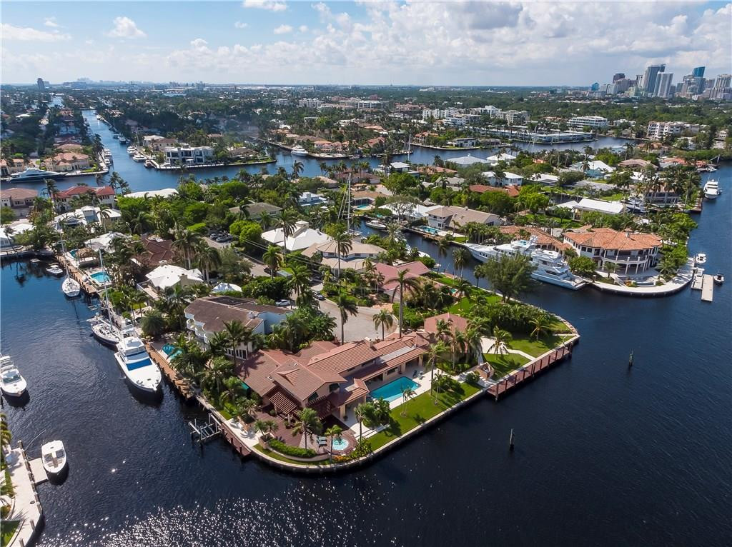 One of a kind oversized point estate with 365 feet of waterfront including over 240 feet on a straight line. Room for multiple super yachts. Wide water views and deep water (over 20 feet in canal) for dockage. Just minutes to the Intracoastal, Port Everglades and the Atlantic. Meticulously maintained home with 7 bedrooms, 6 full and 2 half baths offers great entertaining and living areas inside and out. Drive through garage for yacht provisioning. A separate apartment for staff and crew too.