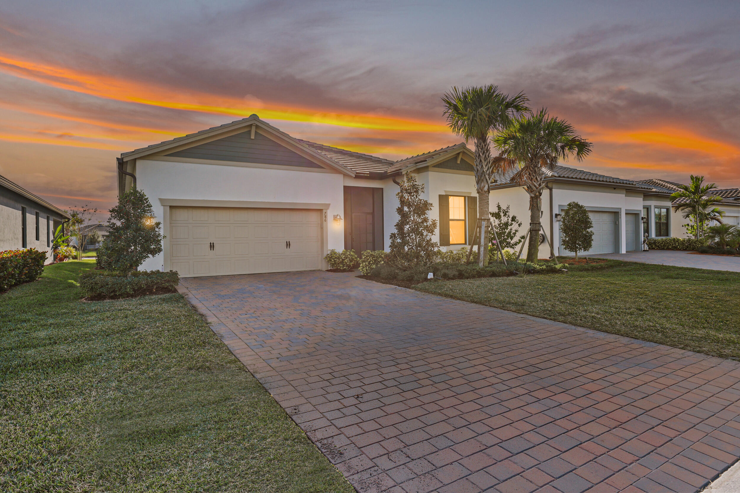 Now priced well under the comps!  CDDs PAID OFF!  This 2023-built lakefront home in Veranda Gardens offers everything buyers are searching for including impact windows, open-concept layout, high ceilings & modern finishes, w/out the added cost, delays or post-closing upgrades.  Over six figures in upgrades are already complete. The kitchen features a gas range, quartz countertops, 42" cabinetry, designer backsplash, large island & pantry. Clean, modern design throughout with move-in ready finishes.  The covered patio and extended screened lanai overlook wide water views with some of the best sunset views in Veranda Gardens. Move-in ready. Lakefront. Fully upgraded. One of the best values in Port St. Lucie real estate.   Located in Veranda Gardens, a gated, amenity-rich community in South Port St. Lucie offering a true Florida lifestyle. Residents enjoy access to a clubroom, resort-style pool, lap pool, fitness center, tennis, pickleball, bocce, basketball courts, dog park, and playground.  The HOA includes lawn care, irrigation, security system, and full access to all community amenities, creating a low-maintenance living experience.  Ideally situated with easy access to I-95, the Florida Turnpike, Palm City, Stuart, area beaches, shopping, dining, and Palm Beach County, making it a strong option for commuters.
