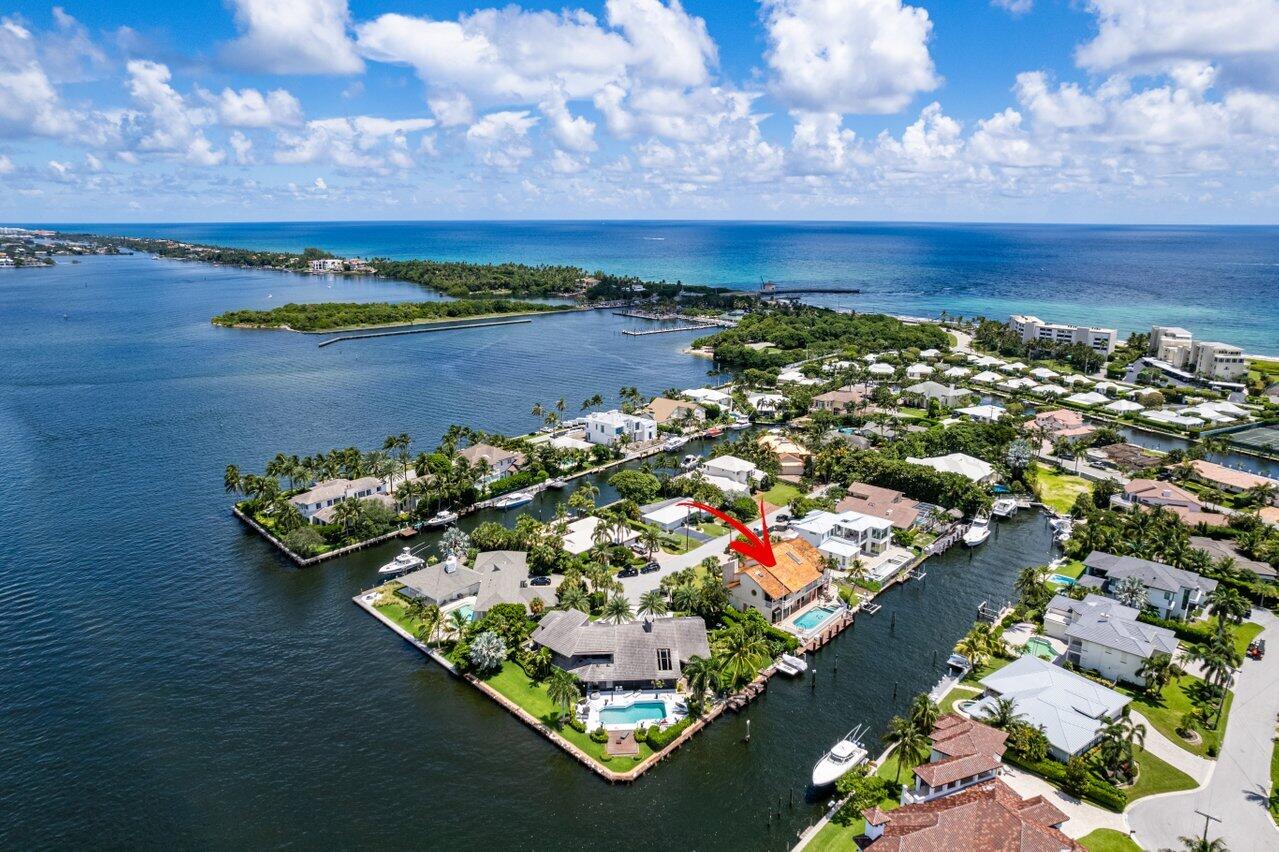 Enjoy Waterfront Living in a Beautiful Ocean Ridge Estate Home
Whether it's a boating lifestyle or carefree entertaining, this 5600-SF three-story, 5/BR-5/BA home is a perfect choice for your south Florida lifestyle.
You'll be thrilled with the look and feel of the home's expansive open floor plan with porcelain flooring, high volume and vaulted tongue-in-groove wood ceilings all bathed in fabulous natural light with incredible waterfront views throughout the main level.
Entertaining is easy in the family room or the living room which incorporates a unique conversation pit with built-in seating in a lower section of the room with a wood burning fireplace, for added ambiance.  Adjacent to the living room is a separate library/office suite with an expansive built-in bookcase imported from Spain, wood beamed ceiling, natural light through large windows that provide incredible exterior views.
The gourmet kitchen features a large center island prep and cooking area, beautiful natural quartzite countertops, custom tile backsplash, state of the art appliances, and solid wood custom cabinetry.
A family dining area is next to the kitchen where you can have casual meals and enjoy views of the patio, pool, and waterway. The large formal dining area is just a few steps from the kitchen, with access to the fabulous nearby wet bar.
The second level of the home has beautiful wood flooring throughout, and the master bedroom has vaulted wood ceilings, a large sitting area, direct walkout access to the balcony level patio overlooking the pool and Intracoastal Waterway, large walk-in closets, and a custom spiral staircase, one of four ways to access to the third floor. 
The ensuite bath features dual sinks, a large Jacuzzi tub, separate walk-in shower, as well as direct access to balcony level patio.
The custom pool with spa is surrounded by composite decking and a beautiful fence. For the yachtsman in the family, this property includes 60 feet of dock and deep waterfront that can accommodate up to an 80-foot vessel. Includes an automatic boat lift for up to a 30-foot boat. The nearby Boynton Beach Inlet provides easy ocean access.
In addition to living in the quiet, secure, upscale community of Ocean Ridge, you're just a few minutes' drive from world class fine dining and shopping in nearby Boca Raton and along Worth Avenue in prestigious Palm Beach, and the Palm Beach International Airport is a short drive from your luxury home.