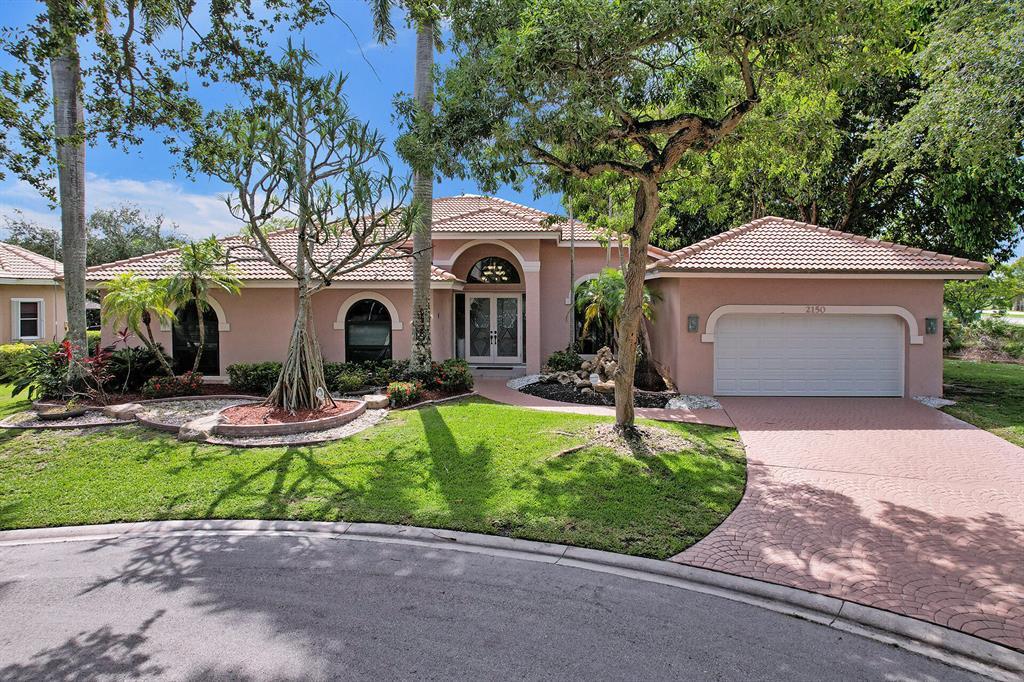 Stunning 4-bedroom home on a 1/4-acre corner lot at the end of a quiet cul-de-sac in the prestigious gated golf community of Eagle Trace. Features elegant marble floors, a beautifully updated kitchen with heat-resistant quartz countertops, double wall ovens, cooktop, wine cooler, new appliances, and reverse osmosis water filtration. The spacious primary suite offers a sitting area and his-and-hers walk-in closets, while all bedrooms include walk-in closets. Updated baths feature dual vanities. Enjoy a formal dining room, large family room, impact windows throughout, A/C units (2019,2024), and a spectacular fenced pool with waterfall—perfect for relaxing or entertaining.