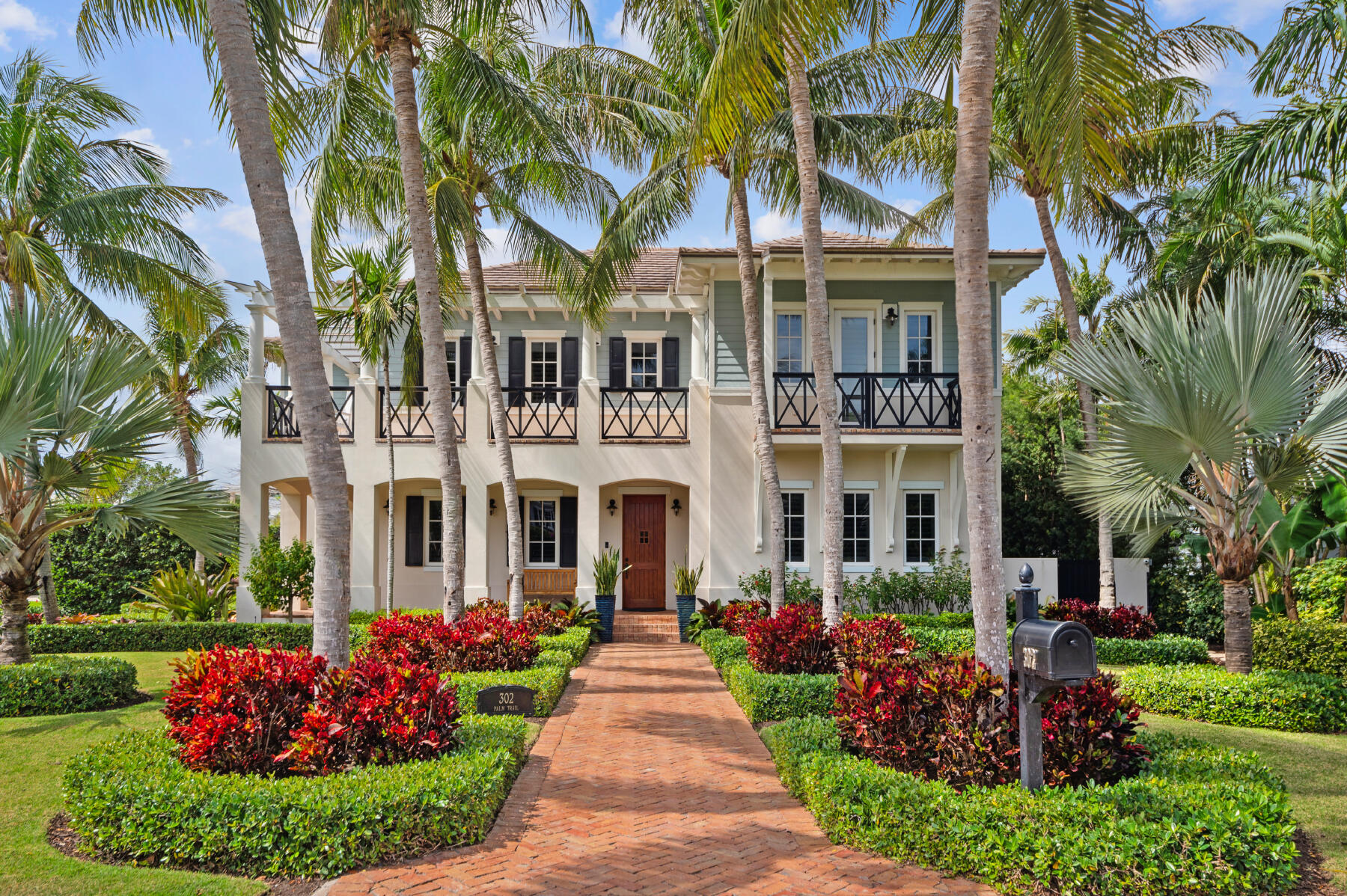 Nestled on the highly sought-after Palm Trail in Delray Beach,, this British West Indies-inspired gem seamlessly combines luxury and comfort with timeless appeal. From the inviting warmth of Brazilian cherry floors to the finely crafted, classically styled millwork, every detail of this residence exudes sophistication and charm. Step inside to discover an open floor plan that effortlessly flows from one area to the next, creating an ideal space for both relaxation and entertainment. This beautifully landscaped corner property offers the epitome of gracious living, with four bedrooms, four full baths, and one half baths spread across 5,288 sq. ft. The soarig 10 ft ceilings and impact windows flood the home with natural light, creating a bright and inviting atmosphere throughout.. Convenience meets luxury with a two-car garage providing ample parking space. Whether enjoying the indoor comforts or basking in the outdoor oasis, this perfectly designed gem on Palm Trail in Delray Beach offers a lifestyle of unparalleled elegance and refinement