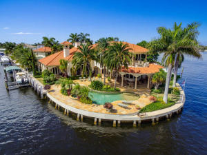 Private estate located on south-east point lot over looking the intercoastal waterway and Spanish River Park. 100 foot dock able to accommodate a large yacht. Six bay garage for the car collector with private motor court.