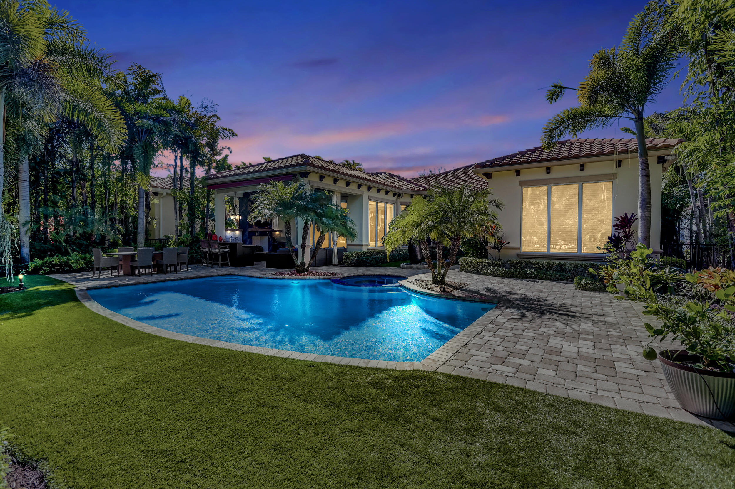Masterfully designed, this exquisite pool home boasts the perfect combination of a private retreat, yet generous space for both inside and outdoor entertaining. Recently renovated with impeccable craftsmanship, this stunning home is nestled on one of the largest GOLF ESTATE lots within the prestigious community of OLD PALM GOLF CLUB.  Offering first class concierge service and resort style living, this rarely available MARTINIQUE floor plan, (custom built by Mustapick), offers formal and informal settings to create a living experience that embodies modern luxuries with casual living. 
This spectacular residence, built in 2012, features 3 bedrooms PLUS custom-built office/den, 3.5 baths, 2.5 car garage, nearly 3,400 SF under air with heated pool/spa and magnificent backyard. Impressive upon entry, this inviting home is adorned with double tray and crown ceilings, stunning marble tile floors in main living areas. Elegant entryway leads to formal dining and living rooms, new wet bar with wine refrigerator and custom cabinetry, and perfectly designed draperies throughout. Incredible gourmet kitchen perfectly equipped with custom cabinets and crown molding, under cabinet lighting, new oversized LG refrigerator, 5-Burner gas cooktop, expansive kitchen island with granite counter tops and sparkling pendant lighting. Spacious breakfast area off the kitchen leads to family room with custom built entertainment wall, all surrounded by hues of natural light. Newly designed and extended office/den, features classic double glass doors, custom built-ins, and LED lighting. Separate laundry room with granite counters, ample cabinets and new Front Load Washer and Dryer.
Grand master suite, nestled in its own private wing, with sparkling pool views, plush new carpet, and custom built-ins in both his & her closets. Luxurious master bath has stunning marble floors and counter tops, dual sinks, expanded vanities with modern lighting, designer finishes and custom draperies, separate jacuzzi tub and oversized shower with frameless glass and decorative tile. Both family members and guests will love the 2 generous bedrooms and guest bath completely remodeled with spa-inspired design, frameless glass shower, custom vanity, and mirror. Bask in your private outdoor paradise! This home raises outdoor living to a new level of beauty + enjoyment! This magnificent backyard is complete with radiant pool/spa with new equipment and SMART phone controls. Picturesque spa wall custom-built and elegantly designed with tranquil fountain and decorative rocks. Oversized covered patio with incredible detailed Pecky Cypress ceiling, LED lights, built-in grill and full summer kitchen, with magnificent fireplace encased in marble. Tropical lush landscaping throughout with new exterior lighting in both front and back yards. This exclusive and unique lot backs to enormous preserve land with winding water feature. A beautiful lifestyle awaits you...
Form meets highest end function in every detail including updated security system and SMART doorbell, new safe installation, new shutters, new TV's and Sonos surround sound, and termite system.  The owners took great pride in creating this majestic Golf Estate. From the finest details to the impeccable finishes - this stunning home will leave you speechless.