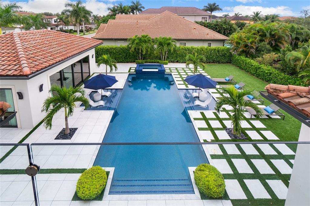Absolutely stunning 2 story transitional estate in the highly sought-after Boca Raton gated community – The Oaks.Large corner lot - 0.35 acres. Main house - 6 bedrooms, 7 full baths, 1 half bath, office, movie theater, spacious loft. Guest house is 600 sq. ft and is set up as a casita with a professional kitchen and dining room/entertainment area. Outdoor oasis features a gorgeous patio, resort style pool, mature landscaping and top-end artificial turf. The Oaks community offers country club amenities – resort-style pool, top tennis facilities, clubhouse, onsite café,  fitness programs for all ages and basketball courts. A-rated school district!