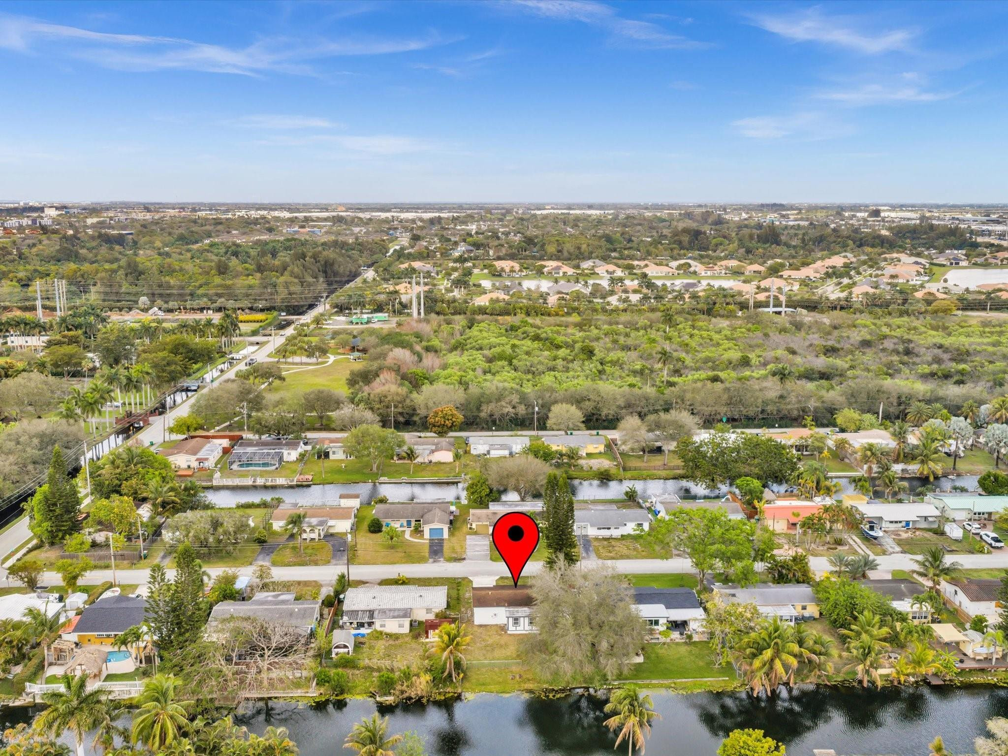 Experience the ultimate in modern waterfront living at 5710 SW 54th Ct, Davie. This stunning 3/2 residence features a sleek California-style driveway and a fully renovated, no-HOA interior. The open layout is draped in elegant tile flooring, leading to a gourmet custom kitchen with a breathtaking waterfall island. Both bathrooms have been meticulously upgraded with designer finishes.The spacious backyard is a private paradise, offering prime lakefront views and the best sunset vistas in South Florida. Enjoy the freedom of no homeowners association in a prime location. This turnkey home combines contemporary luxury with serene outdoor living. Perfect for buyers seeking a move-in-ready, modern oasis with expansive water views.