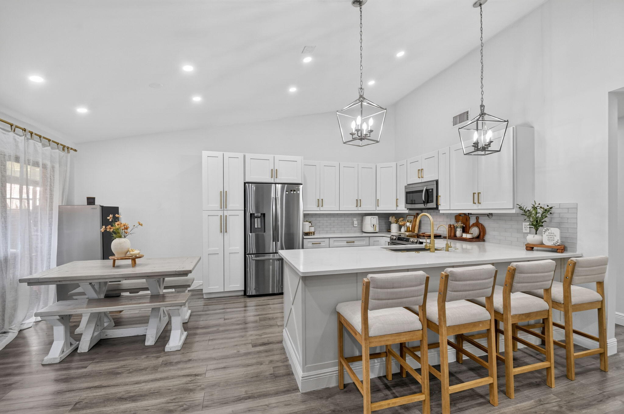 Welcome to this beautifully reimagined oasis in the heart of the highly desirable Palm Springs. This stunning 2-bedroom, 2-bathroom villa feels like a standalone home and has been meticulously updated from top to bottom. The heart of the home is a breathtaking chef's kitchen featuring bright white custom cabinetry, elegant gold hardware, premium stainless steel appliances, and a massive center island with breakfast bar seating under chic designer pendant lighting. High vaulted ceilings and gorgeous new flooring flow throughout the expansive layout. Enjoy complete peace of mind with a brand-new air conditioning system, a new water heater, and completely modernized bathrooms. Fully updated in 2020, this turnkey property offers luxury, comfort, and the low-maintenance Florida lifestyle.