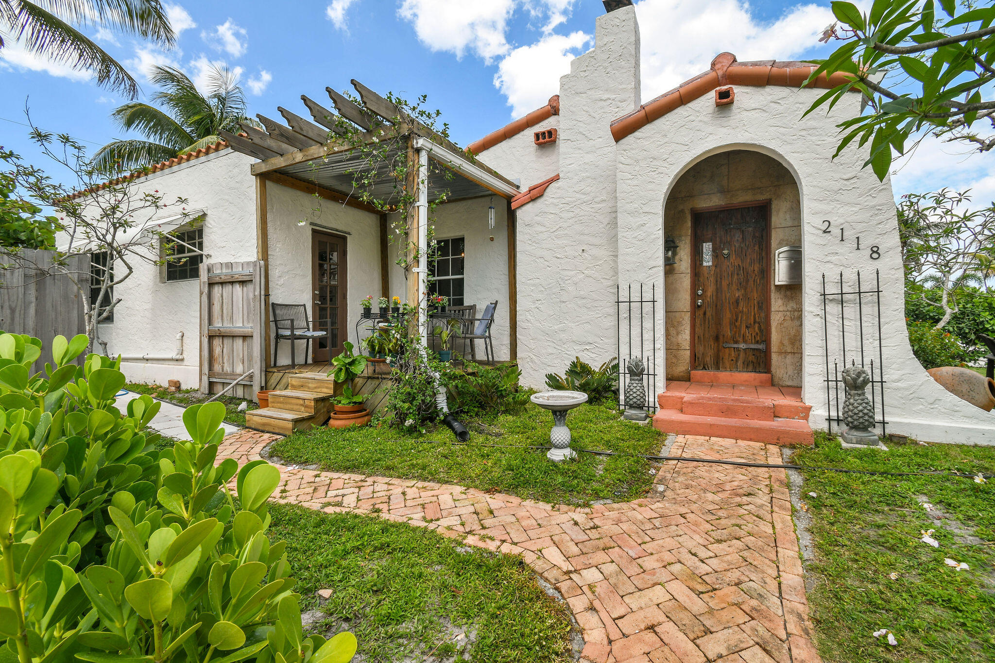 1925 Spanish Mission gem built in hollow tile by Flamingo Park's renowned Hansell Hall. This 3BR/1BA charmer features a sunny bonus room and detached 1-car garage. Original picture-frame hardwood floors add warmth throughout, with tile in kitchen, bath, sunroom, and laundry. The updated kitchen shines with seeded glass cabinetry and tiled countertops. Step outside to an elevated deck with pergola--perfect for stylish al fresco dining. Inside, enjoy a cozy wood-burning fireplace, vintage lighting, and rich architectural detail. The backyard is a private oasis with a pool, spa, outdoor shower, and fenced yard. New roof & A/C (2022).