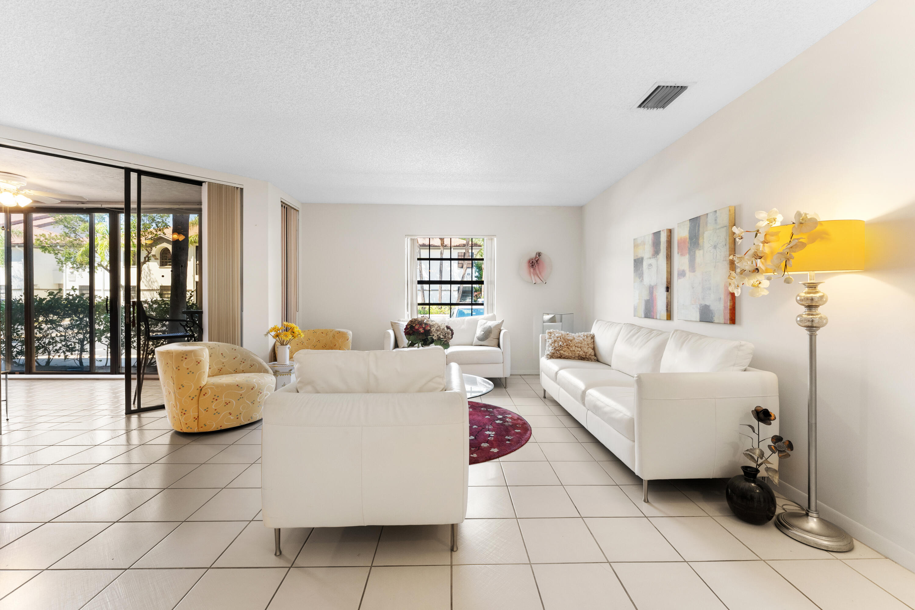 Welcome to this bright and spacious 3-bedroom, 2-bathroom home located in the desirable Carrara Village within Platina Community in Boynton Beach. Filled with natural light, this home features a thoughtfully designed split-bedroom floor plan that offers both privacy and functionality.  The oversized kitchen provides ample space for cooking, entertaining, and everyday living, while the spacious enclosed patio creates the perfect setting to relax, unwind, or enjoy indoor-outdoor living year-round. Hurricane impact windows offer added peace of mind and energy efficiency.  Lovingly maintained, this home presents a fantastic opportunity for a buyer to move right in or customize to their personal style and vision.  Residents of Platina enjoy access to a gated, amenity-rich community  featuring a clubhouse, resort-style pool, fitness center, tennis courts, walking paths, and a full calendar of social activities—perfect for an active and connected lifestyle.  Ideally located just minutes from shopping, dining, and everyday conveniences, you'll be close to destinations like Boynton Beach Mall, local restaurants, and only a short drive to the beautiful South Florida beaches.