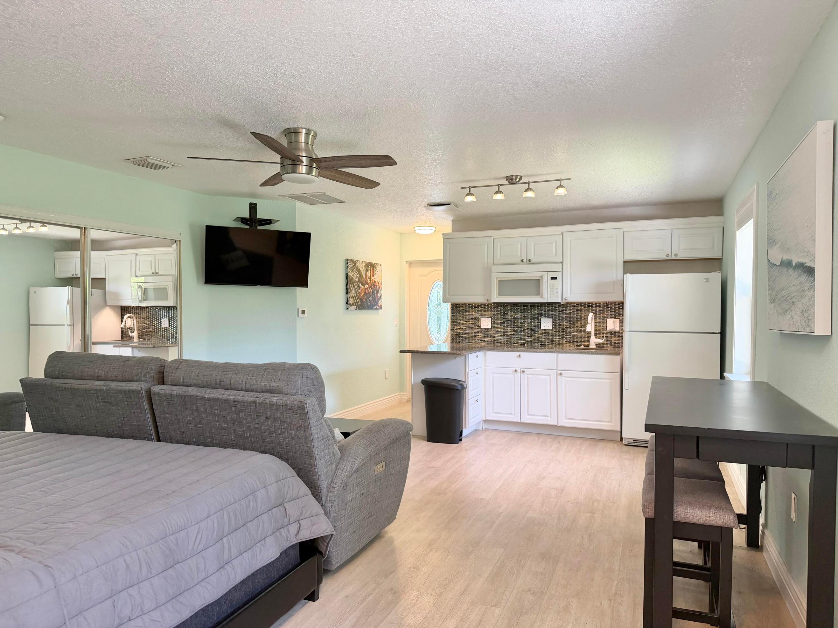 Enjoy easy coastal living in this spacious, fully furnished studio in the heart of Jupiter. Ideally located just east of I-95, with quick access to Alton Town Center, Publix, LA Fitness, restaurants, shopping, and everyday conveniences. Only 5 miles to the beach and 15 minutes to Downtown West Palm Beach and Palm Beach International Airport. Features include a king-size memory foam mattress, power reclining sofa, flat-screen TV, private bathroom with walk-in shower, two oversized closets, and a fully equipped kitchenette with full-size refrigerator/freezer, sink, microwave, two plug-in cooktops, toaster oven, Nespresso maker, and dining ware included. Enjoy abundant natural light, a private entrance, private rear exit, and your own outdoor patio space to relax and unwind. No pets, no smoking. Fully Furnished only, available 7/1