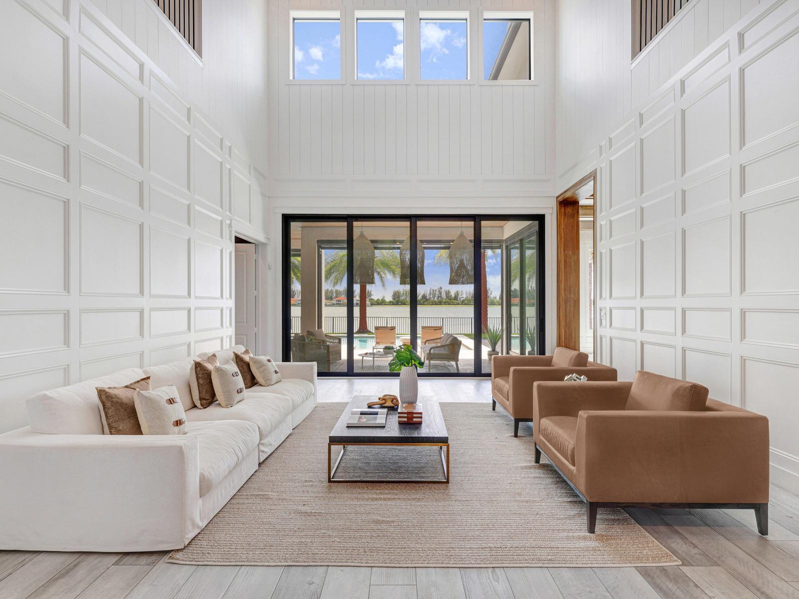Rare opportunity to own one of only 11 Oakmont models in Parkland Bay. Perfectly positioned on an oversized waterfront lot along the community's largest lake with unobstructed sunset views, this extraordinary coastal-modern estate showcases exceptional craftsmanship with extensive custom millwork, architectural wood detailing, bespoke built-ins, designer finishes and curated interiors throughout. Offering 5 bedrooms, 5 full & 2 half baths, a study, loft and 4-car garage, the home is designed for effortless luxury. Enjoy a resort-style pool, outdoor summer kitchen, the community's only grandfathered private basketball court, lush tropical landscaping and exceptional privacy, just a short walk to the clubhouse.