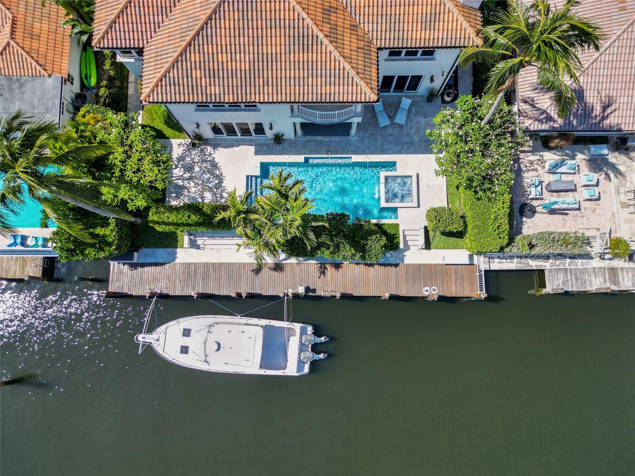 Welcome to this exquisite WATERFRONT estate in the coveted Bermuda Riviera neighborhood. This magnificent home has DIRECT OCEAN ACCESS w/NO FIXED BRIDGES & new 20k lb boat lift. Enter through double doors into a spacious, open floor plan w/high ceilings & large impact windows, flooding the home w/natural light. The gourmet kitchen features Wolf & Sub-Zero stainless steel appliances w/an eat in kitchen/breakfast area. Equipped w/an elevator & state of the art Crestron smart home system. The primary suite offers a walk in closet & balcony. Outdoors, enjoy a private tropical oasis w/a heated pool/spa and 80' waterfront views. Zoned for Bayview Elementary and walking distance to upscale dining & shopping at North Beach Shoppes, this is luxury waterfront living at its finest.