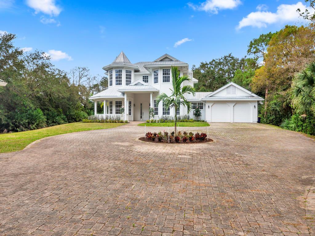 Where do you find a residential property with land in South Florida? 1001 SE Rand Road located in Ranch Colony's exclusive Ranch Estates, the private guard-gated community in Jupiter. The only gated community with 36 residences homesites with 20 to 50 acres. The beautiful winding drive leads you up to his 4-bedroom, 4 bath Victorian home which has a wrap-round porch, fireplace, an office, attached 2-car garage and a separate large, detached 2-car garage. The 2,800 SF house sits on 20 acres, including wetlands and extensive landscaping offering ultimate privacy for the discerning buyer. The Estates also has pastures, barns and Kennels available for residents. 1001 SE Ranch Road is a great opportunity to move right in or built your own ultimate private retreat.