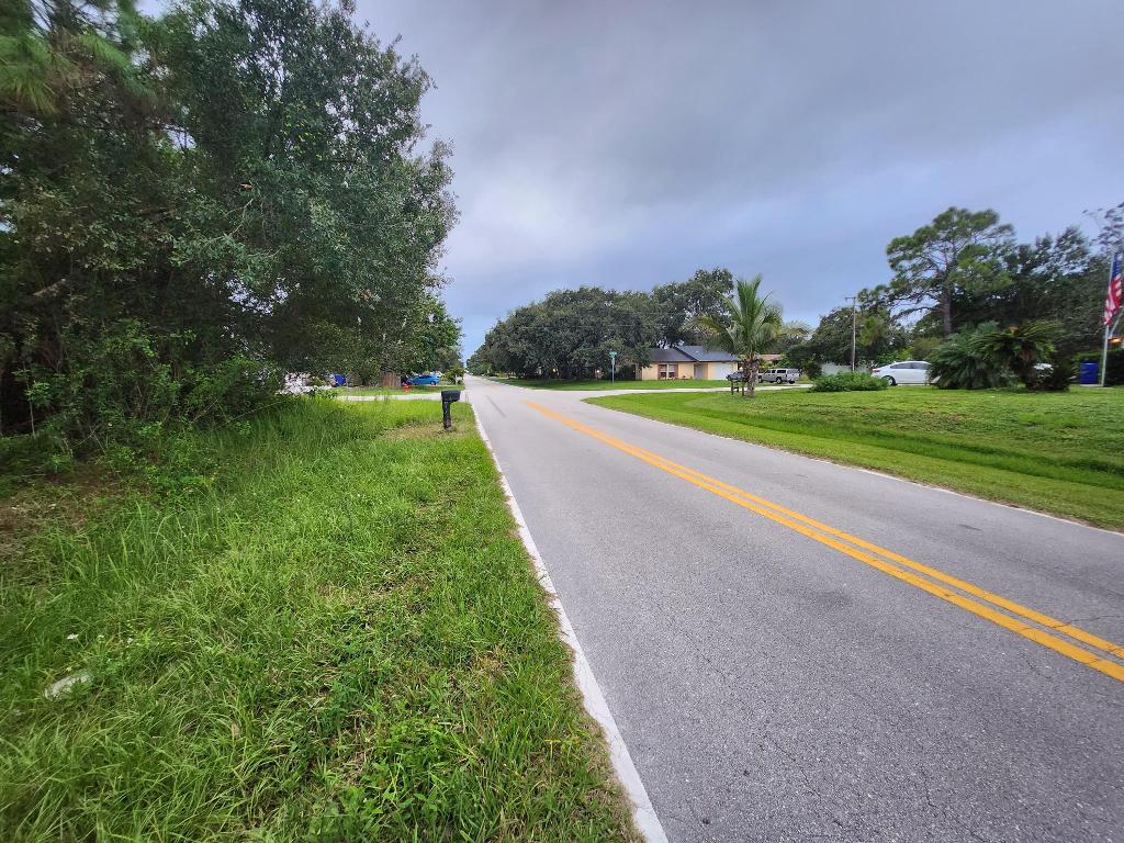 Ready to build your dream home? This 0.25-acre mostly cleared lot on a paved road in the peaceful Paradise Park community offers a blank canvas. this property blends convenience with a laid-back Treasure Coast vibe—20 minutes from Vero's pristine beaches. Surrounded by mature trees along the perimeter, it's got natural privacy and charm without the hassle of heavy clearing. No HOA means freedom to design your space your way. Utilities nearby, high-ground location, and a rare find. this one's primed for your vision!