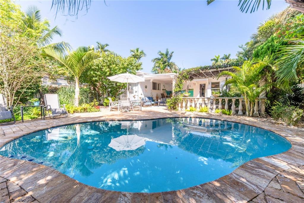 WHAT A BEAUTIFUL HOME!!SITUATED IN MOST SOUGHT AFTER HOLLYWOOD LAKES**MINUTES TO THE BEACH**ON ONE OF THE MOST BEAUTIFUL ROYAL PALM TREE LINED STREET. WELCOME TO YOUR VERY OWN SECLUDED, TROPICAL PARADISE W/FREEFORM POOL, MARBLE PATIO, COVERED ENTERTAING BAR, SHADED PERGOLA, EXOTIC LANDSCAPING, PALM TREES, LIGHTING AND SO MUCH MORE***VERY OPEN AND SPACIOUS W/ALOT OF NATURAL LIGHT***HURRICANE IMPACT GLASS THRUOUT, NEW UNDERGROUND PIPES, UPDATED ELECTRIC, MARBLE FLOORS IN LIVING AREAS, SOLID WOOD FLOORS IN BEDROOMS, UPDATED KITCHEN CABINETS, STAINLESS STEEL APPLIANCES, WINE COOLER, GRANITE TOPS. LARGE MASTER SUITE, CUSTOM CLOSET, ALL UPDATED BATHS, AND PLANTATION SHUTTERS***20X10 ART/YOGA STUDIO W/AC AND IMPACT WINDOWS, 4 CAR DRIVEWAY AND PLENTY GUEST PARKING ON STREET***