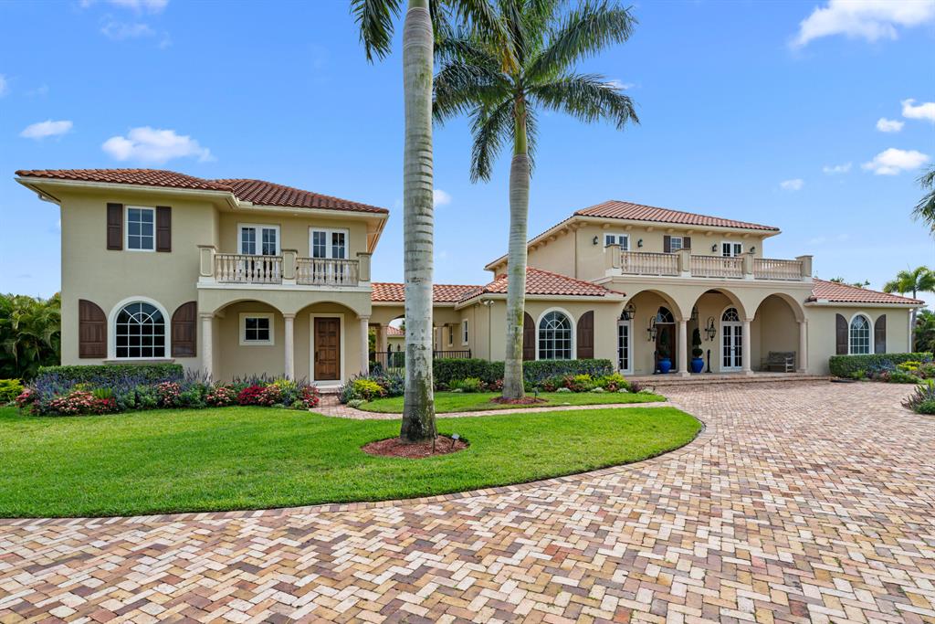 Fabulous family equestrian compound just a short hack to the Palm Beach International Equestrian Center. Custom built home features 5 bedroom and 5.5 bath plus office. Additional features include downstairs master suite, two laundry rooms, whole house generator, saltwater pool and spa with gas heater, Chicago brick driveway and pool deck, two oversized two car garages plus golf cart garage. Newer luxury one bedroom guest apartment with kitchen and laundry. Family entertainment features include a lighted tennis court and covered outdoor dining patio with storage. Equestrians will love the 7 stall stable with tack, feed and laundry rooms plus two separate staff quarters. Large grass jump field and 7 paddocks complete this ideal property for horses and humans alike.