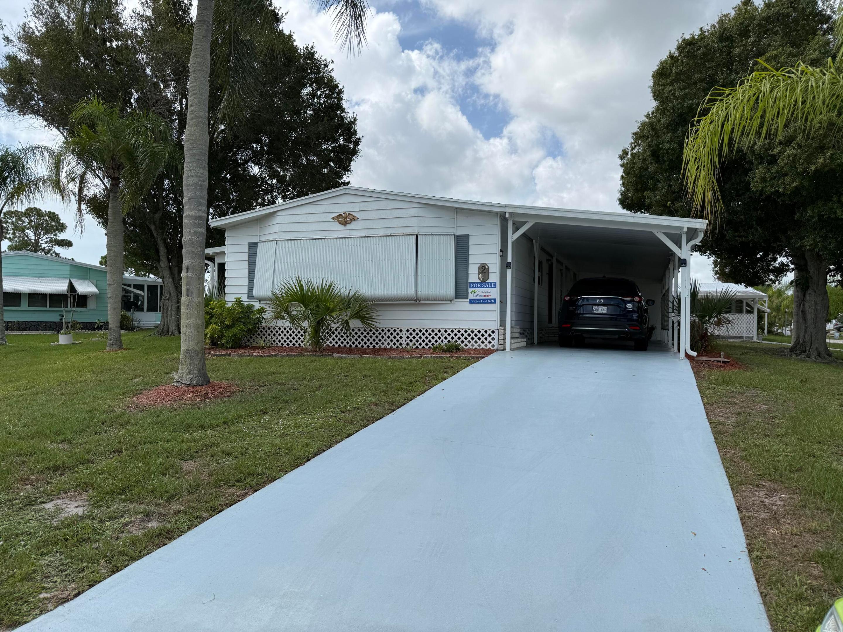 Welcome to this charming, fully furnished 2-bedroom, 2-bathroom manufactured home nestled in the 55+ community of Spanish Lakes Country Club Village in Fort Pierce, Florida. With 1,600 square feet of finished living space, new roof in 2016, A/C in 2020 and a spacious Florida room this one-story home presents an accessible floor plan ideal for those seeking straightforward, manageable living in an established community. Discover the appeal of Spanish Lakes Country Club Village living with an excellent opportunity for buyers seeking an affordable home near beaches, restaurants and shopping.  Lawn care and trash removal are included in the lot rent. The community features two pools, golf, tennis, pickleball, bocce ball, shuffleboard, Clubhouse and much more. Land lease is $1074