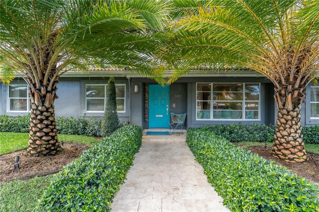 Come home to resort style living in this large corner lot South Coral Heights stunner.  Enjoy indoor/outdoor living in the professionally architected backyard lanai overlooking the saltwater pool. Full custom outdoor stacked stone and granite built in kitchen with sink, Bull grill, and refrigerator. Enclosed outdoor shower off the primary bedroom. The backlit primary bedroom has a dressing area and custom built-in closets. The third bedroom has been converted into an office/media room with custom cabinets. Beautifully tiled eat-in kitchen with colorful Jonathan Adler sink, bar seating, and additional wine fridge. A second full size refrigerator is located in the garage. Lots of closet and storage space. Large circular driveway. Outdoor lighting on all landscaping. Low maintenance lawn.