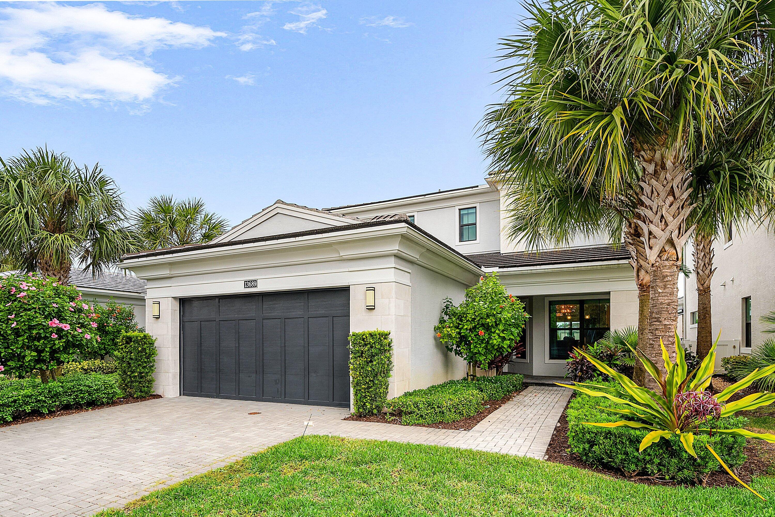 EXPANSIVE LAKEFRONT POOL HOME WITH DOWNSTAIRS PRIMARY SUITE. This highly desirable Francesca Model sits on one of the most premium lots, centrally located in the quietest section of Artistry, creating a peaceful oasis, while still walking distance from the clubhouse amenities. The home can be purchased conveniently with Restoration Hardware furnishings (pictured), just bring your toothbrush! Boasting 3162 sq. ft. of living space, the floor plan is perfectly suited for guests. Featuring a large ground floor primary bedroom, 2 upstairs guest suites with walk-in closets & ensuite bath, plus an additional loft (flex space or 4th bedroom). The property is loaded with upgrades like oversized porcelain tile flooring, custom window treatments, high end carpets, designer  light fixtures, and contemporary metal stair railings. The Kitchen is outfitted with modern white shaker cabinets, marble backsplash, GE Profile Appliances, gas cooktop, double wall-oven/convection microwave, and a breakfast nook that gets lots of natural light.  The open concept downstairs is surrounded by inviting lake views in every direction. 8ft 3-panel sliders seamlessly blend indoor and outdoor living spaces perfectly capturing the South Florida Lifestyle. The fenced in private backyard is also loaded with upgrades like extended travertine decking, salt water pool, hot tub, and fully equipped summer kitchen, all surrounded by lush mature landscaping.  The Owner's Suite is complete with tray ceilings, a walk-in closet, and a beautifully appointed bathroom, outfitted with a double vanity, soaking tub, and oversized walk-in all-glass shower with a bench seat, rain shower head, and floor-to-ceiling tile!  Artistry Palm Beach Gardens is an exclusive gated community, situated in prestigious Palm Beach Gardens, surrounded by premier golf courses, beaches, fishing, boating, world-class shopping, dining entertainment, A-rated schools. All while in close proximity to PBI airport, Palm Beach Island, arts and theatre, and so much more! Community amenities include a resort style pool and cabanas, fitness center, bocce court, basketball court, fitness trail, and 24-hour manned security.